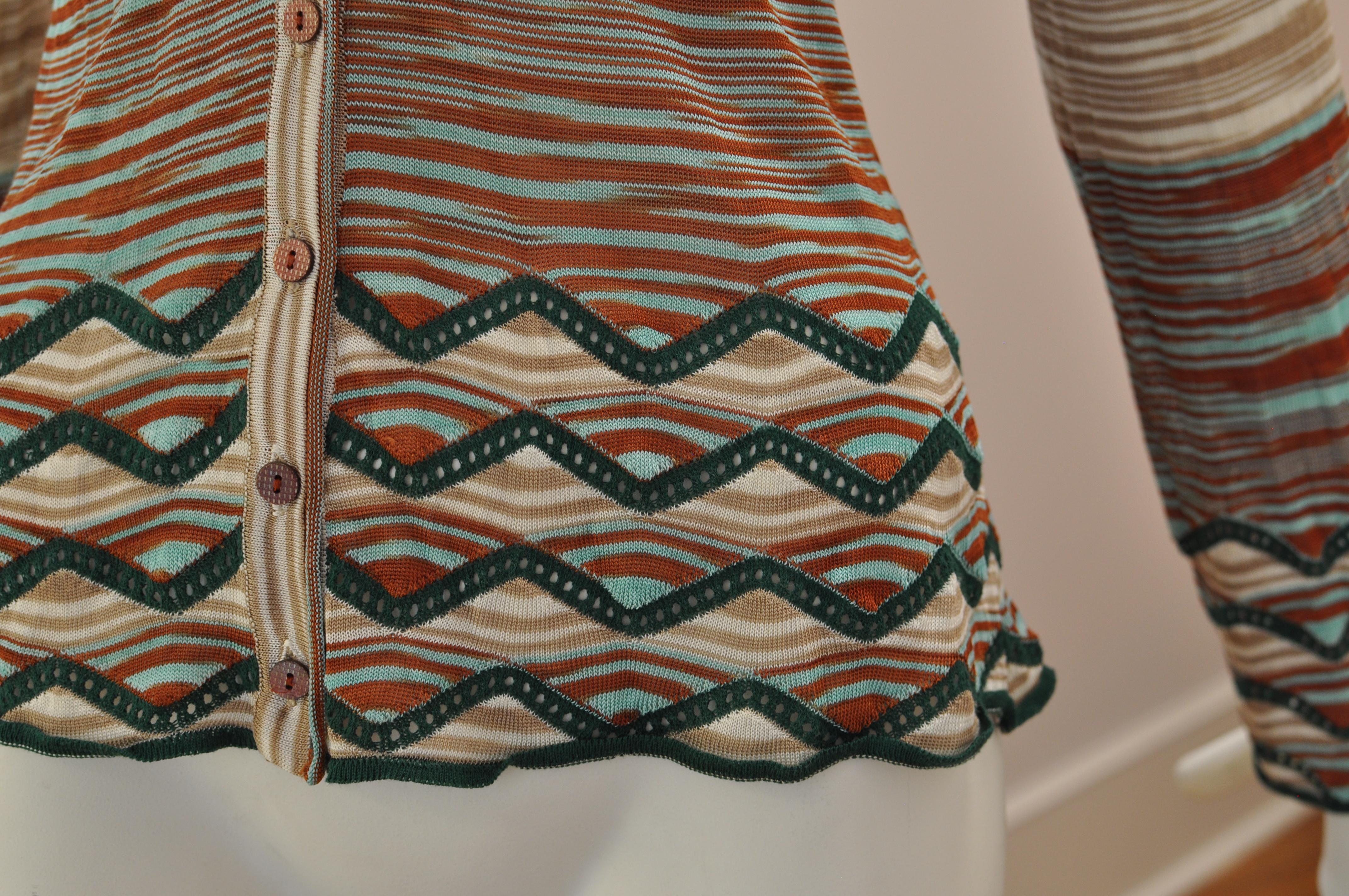 A mix of colored (russet/green and beige) line and green zig zag pattern at the hem and cuffs, this is an iconic Missoni piece.