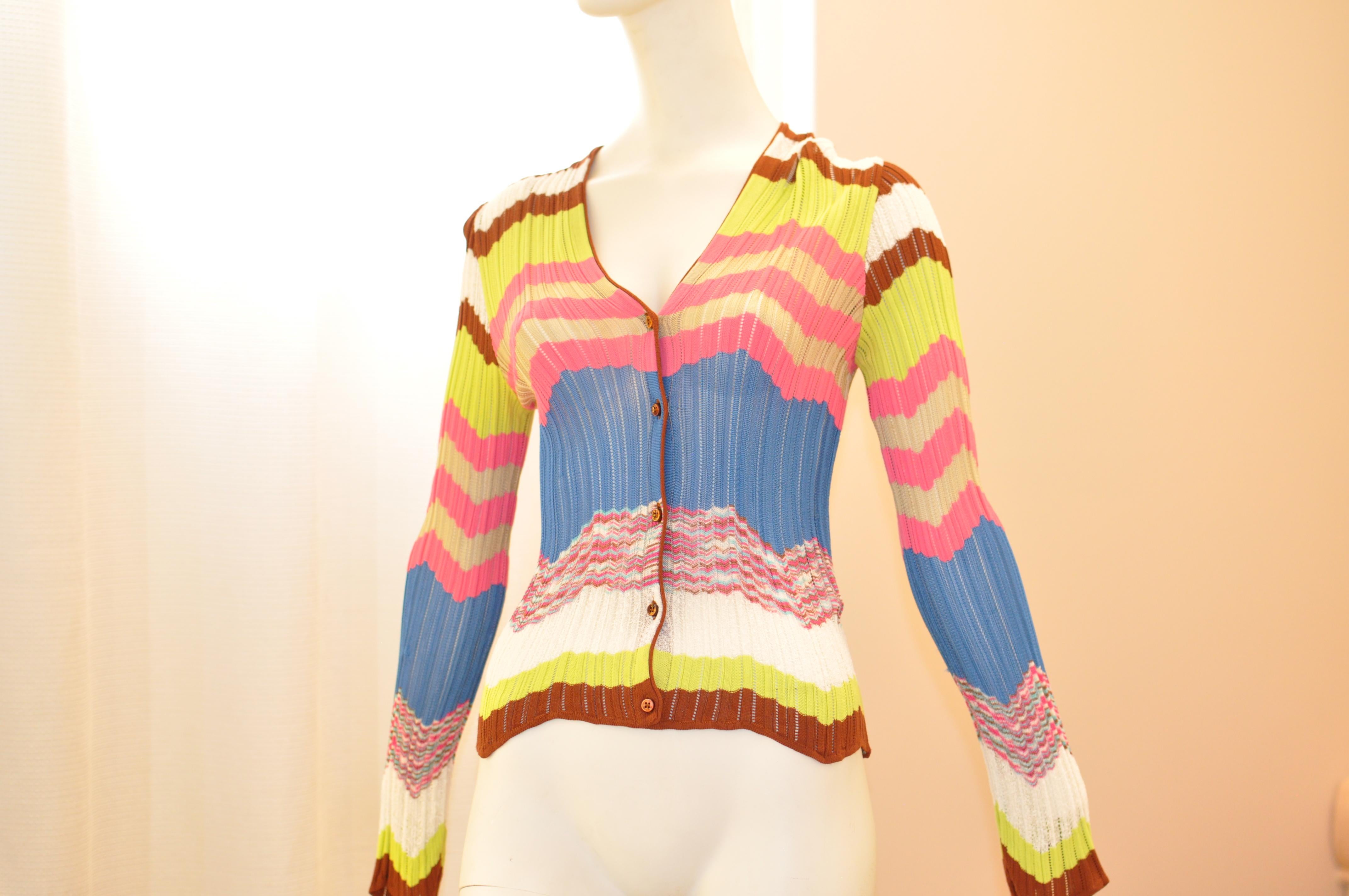 A burst of color which will enliven any outfit. The viscose cardigan has a number of zig zag patterns interspersed with solid colors. The sleeves are long and have handkerchief hems.