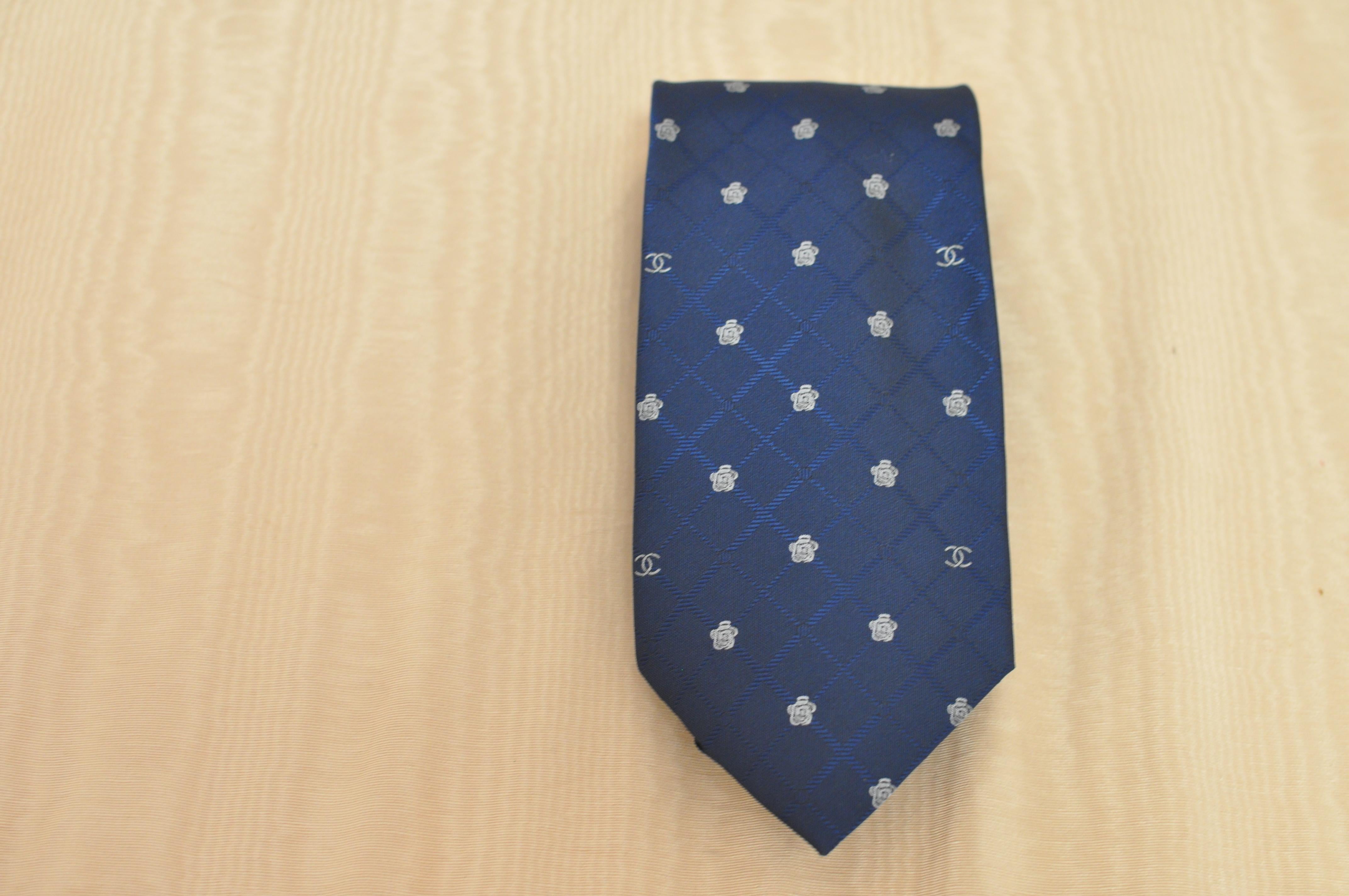 Dark blue criss cross pattern background with a contrasting cc and camellia flower print. Made in Italy.
