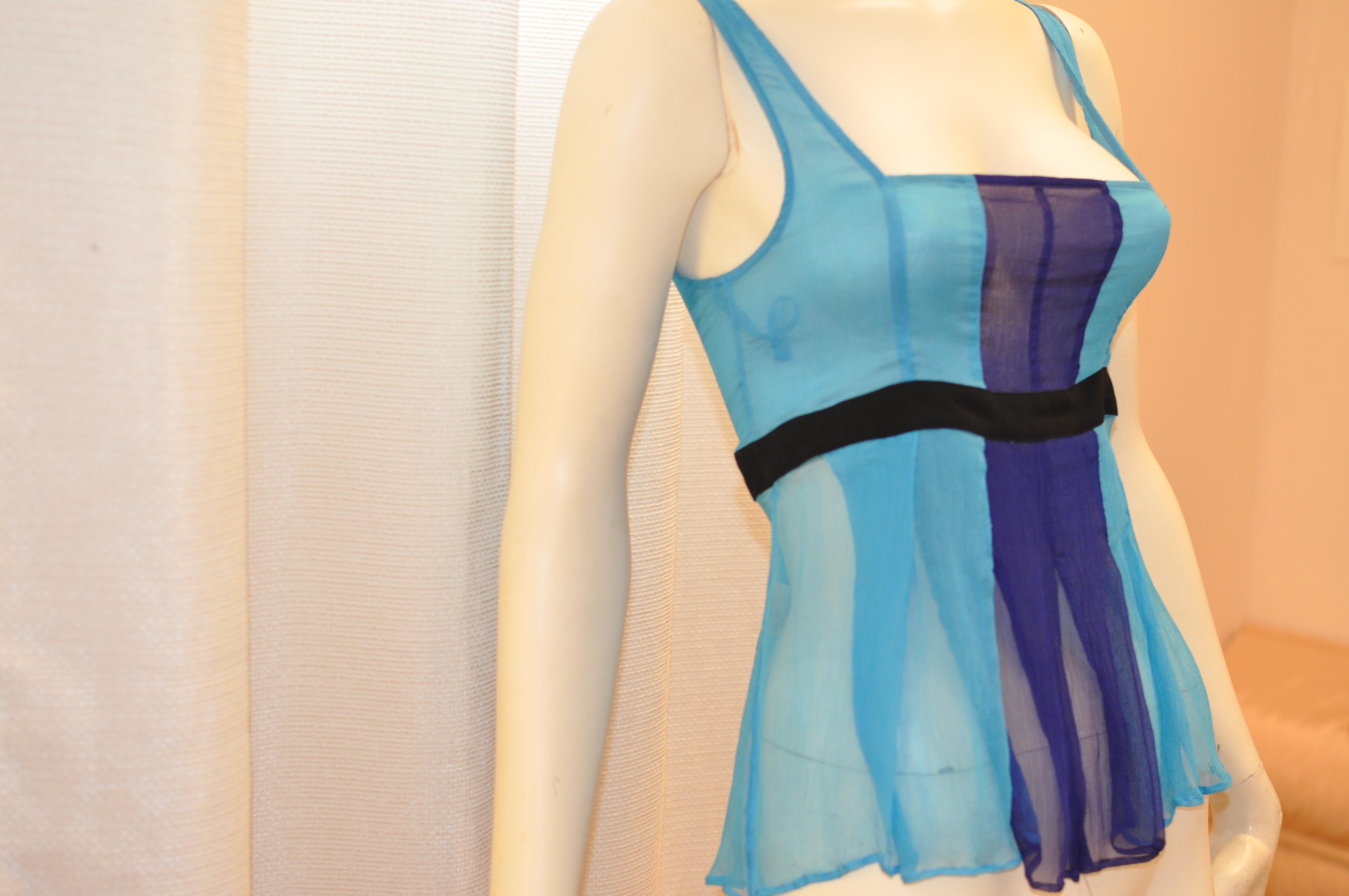 Perfect little top for the warm seasons! This silk top has a mainly aqua blue background with a royal blue panel in the center front and a black band at below the bust.

The neckline is square, and the below the waist pleating hangs nicely.