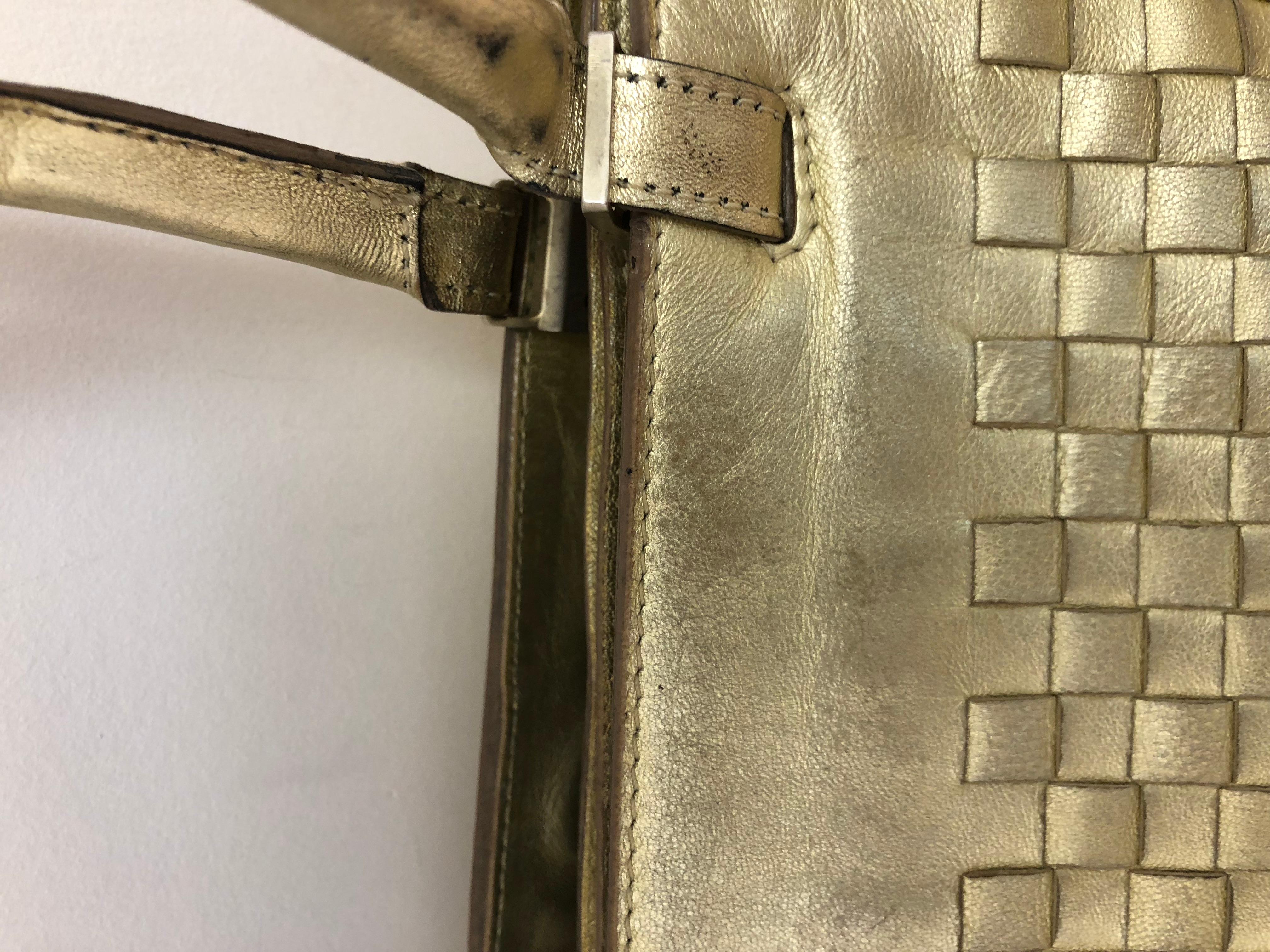 In fair condition because of loss of some of the gold patina, a few pen marks on the inside, and a magnetic closure which requires some repair, the price reflects these fixable faults.

The bag features two separate compartments one with a top zip