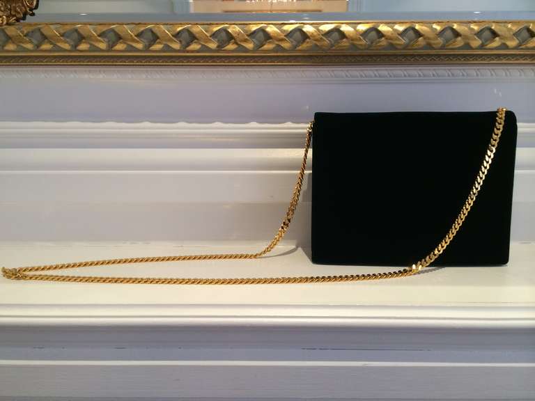 Exquisite Valentino velvet clutch in deep forest green with luxurious gold chain. 
Chain is long and detachable. Lined in signature Valentino red silk. Chic--easily worn with black.    

Striking in its simplicity this bag is forever Valentino.