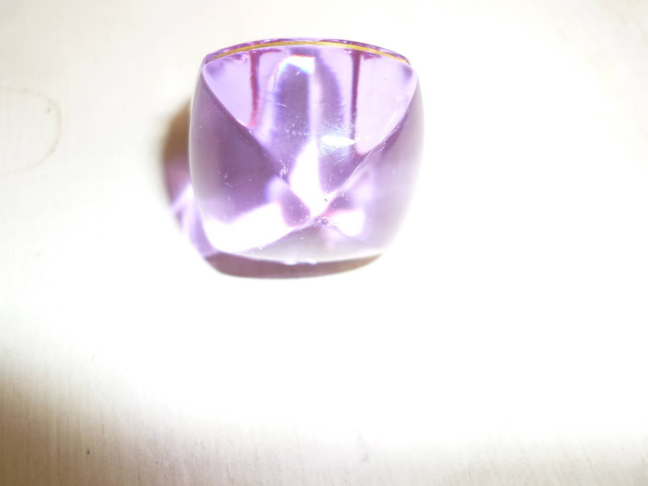 Beautiful light blue ring with a tinge of purple depending on how the light hits it! It is made of glass with a gold tone surround of the cabochon and has some weight to it. The ring is a small size with a 6cm circumference, has never been worn and