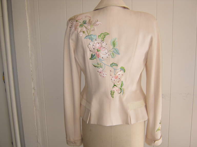 An amazing jacket with so many details such as fine embroidery on the shoulder sleeve and back; soft leather trim and bows, and peplum effect.

The silk lining has the DIOR print as do the mother of pearl buttons. This jacket is perfection!