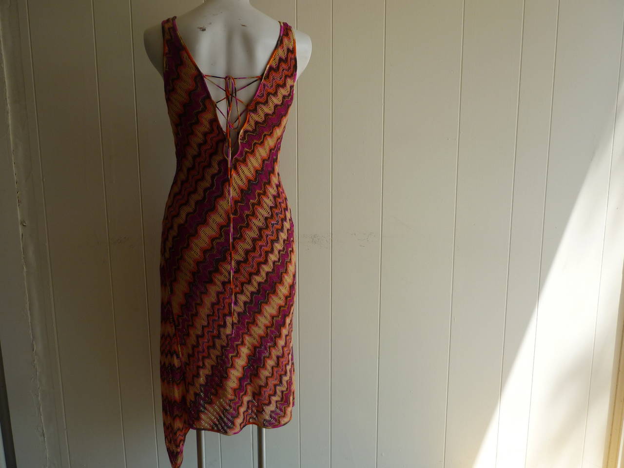 This fully lined crochet dress in the very recognizable Missoni pattern has some lovely details including a v-neck, uneven hem line and criss-cross lace up back.