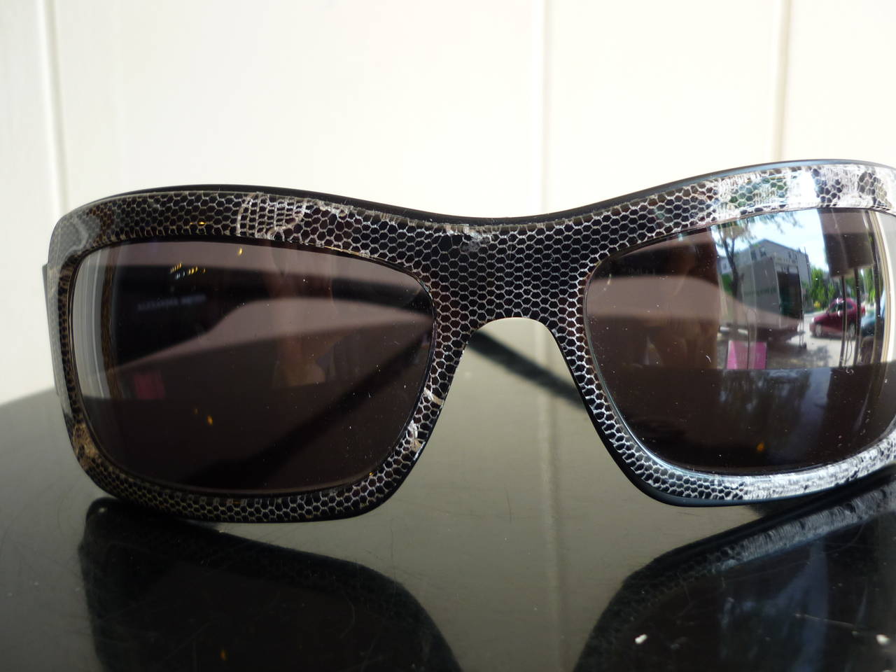 As new, these beautiful sunglasses have frames which look like a snakeskin pattern in grey/black, and dark  grey UV gradient lenses.

They come with a beautiful grey case (see pictures), and are made in Italy.