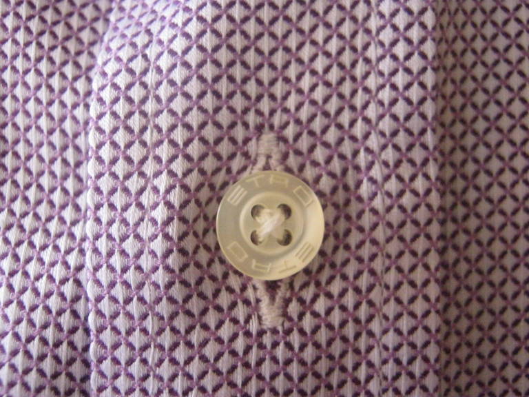 A pattern of small diamond shapes in a light lilac and white, makes this shirt highly wearable with a suit, dress or sport pants.

It is made of a cotton which is silky but has a lot of body, and all buttons have ETRO on them.