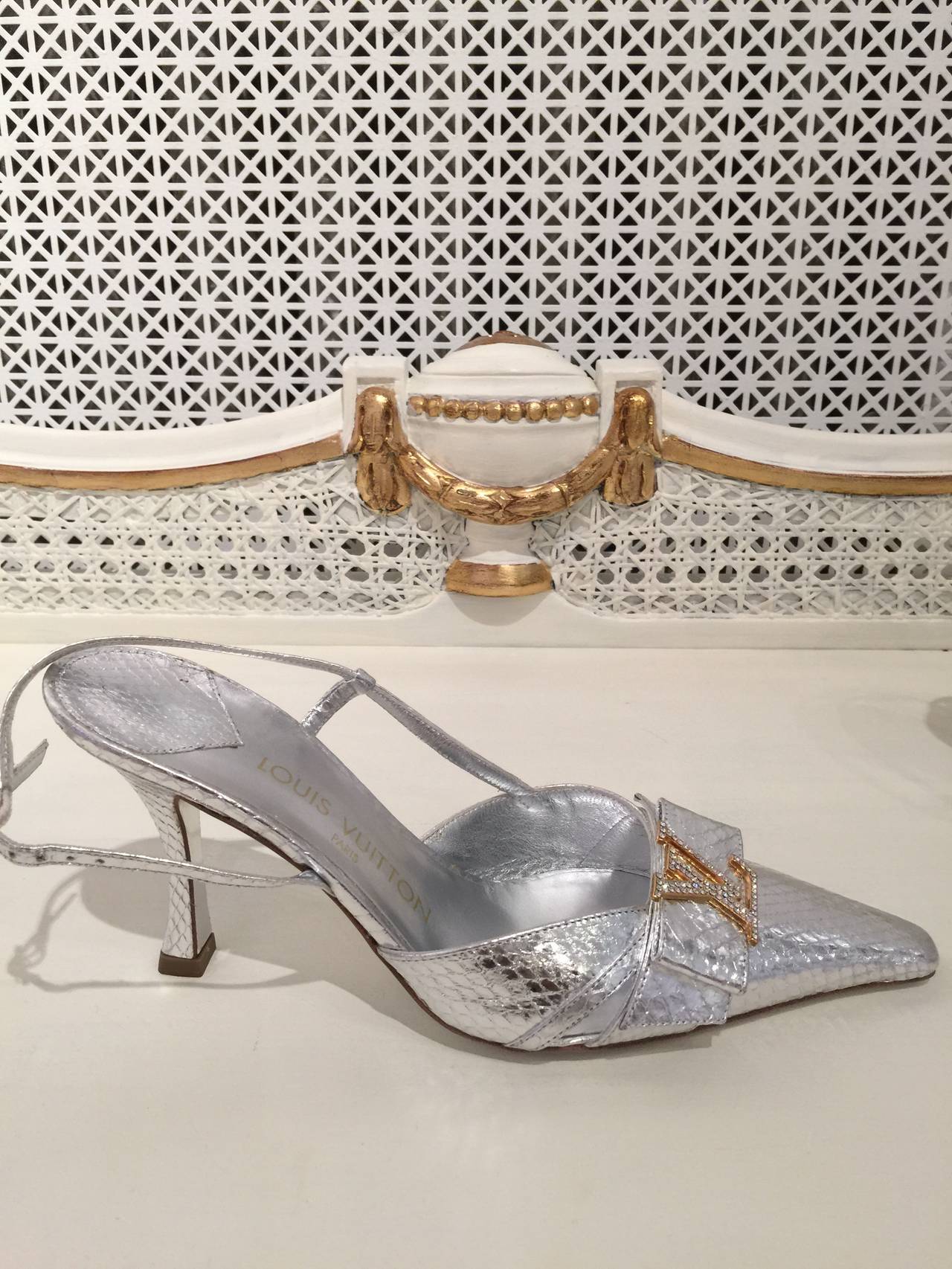 Beautiful and Impeccable Louis Vuitton metallic silver pumps.
With crystal encrusted goldtone monogram emblems at the vamp.
Pointed toes with buckle closure
Size 37