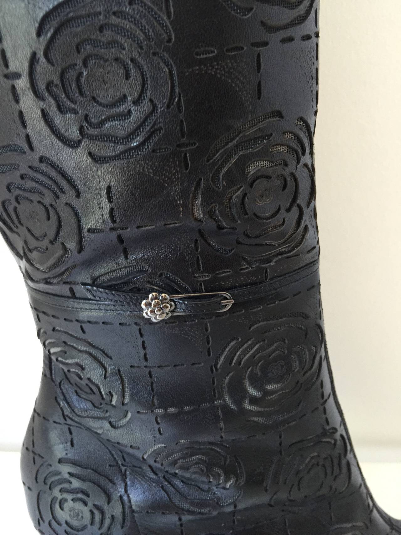 Boots with gorgeous details...leather with pointy toes...
camellia flowers embossed all throughout the boot ...side zipper
high stacked heels,,,,wear with a skirt or tucked into jeans....