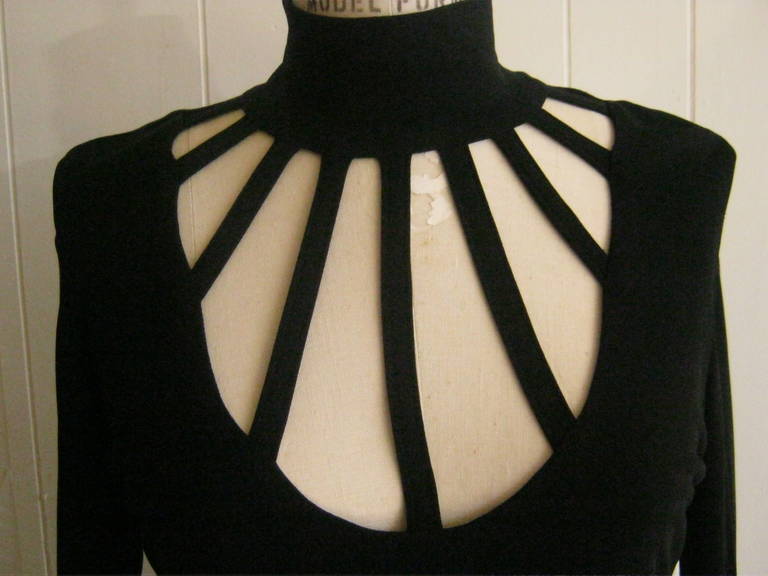 This black double jersey top falls beautifully and the web cut-out is elegantly sexy matched with the high neck.

The closure is by a hidden zip in the back.