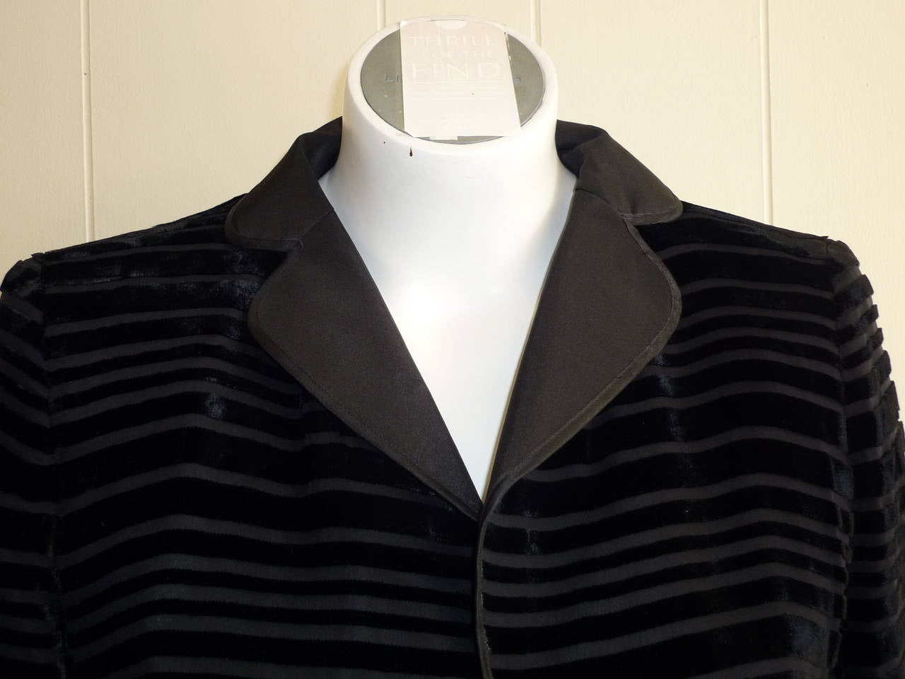 Horizontal ribbed velvet with a black chiffon base, this jacket sports a notched lapel and french cuffs. Closure is by way of a single button. The materials re 77% viscose 23% silk.