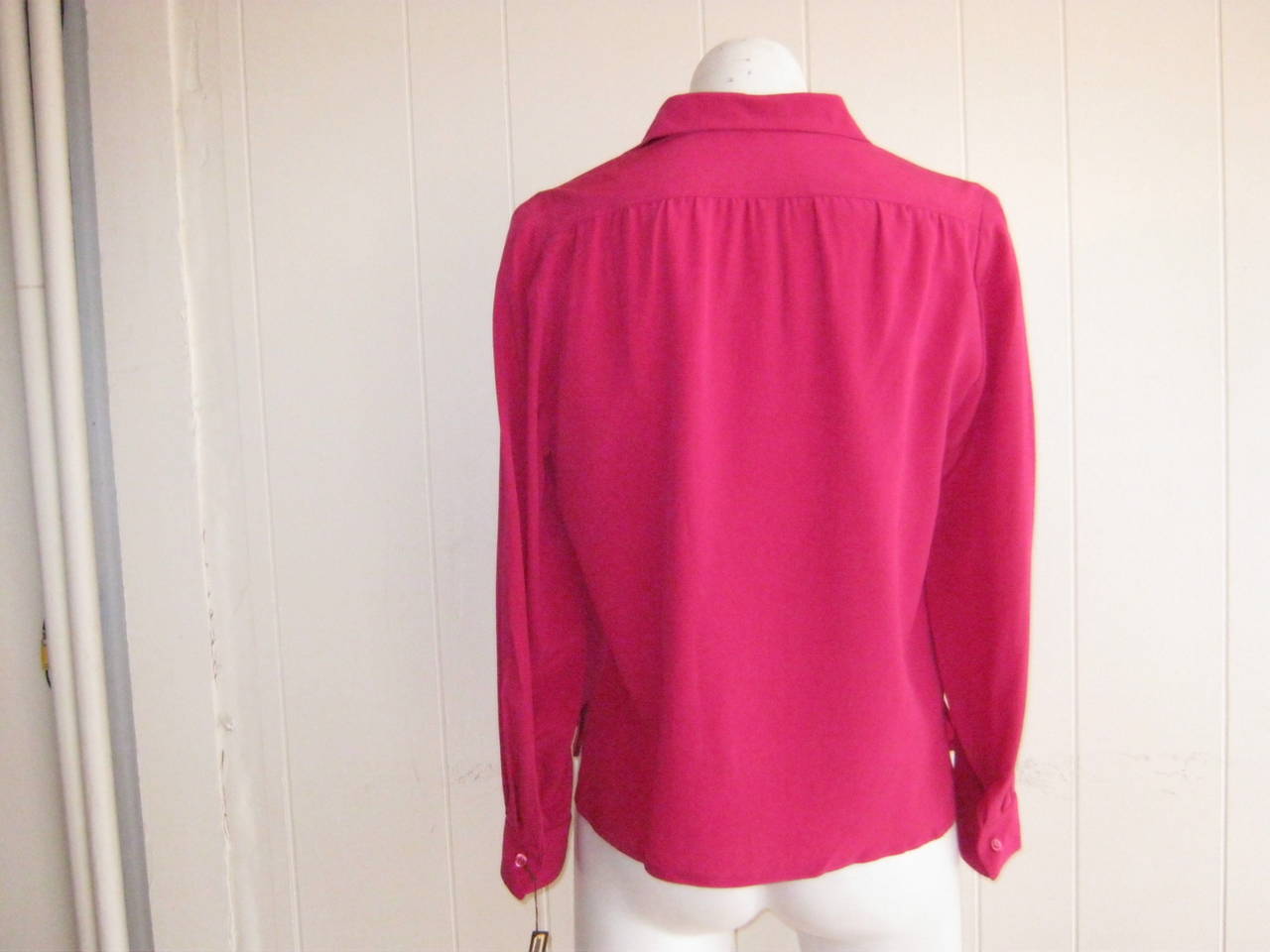 Wonderfully simple and elegant, this silk blouse still carries the original plastic tag with a price of $475.

The only sign of the 1960s is the slight blousing below the collar in the back.