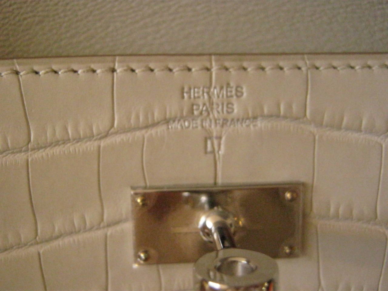 Stunning Hermes wallet which can double up as a clutch, and be used day or night. This Hermes wallet has never been used and comes with its protective felt, box and ribbon. It has palladium hardware with the plastic still on; two straps with the Q