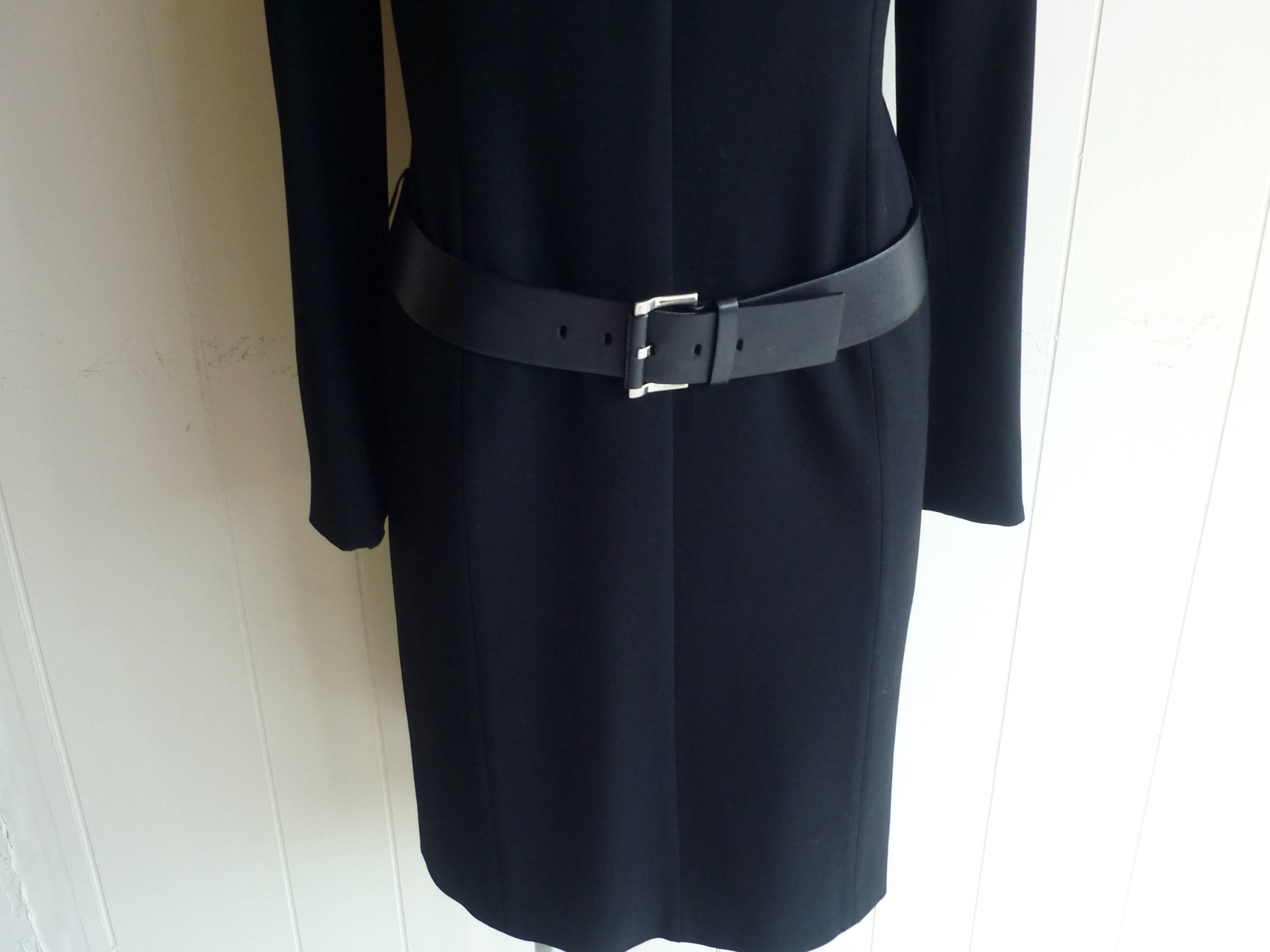 Minimalist, well tailored dress with a drop waist and lovely leather belt at hip. The dress has a round neck with two decorative metal snap button which create a fold. These are replicated on each cuff.

Fully line the dress is simple and elegant.