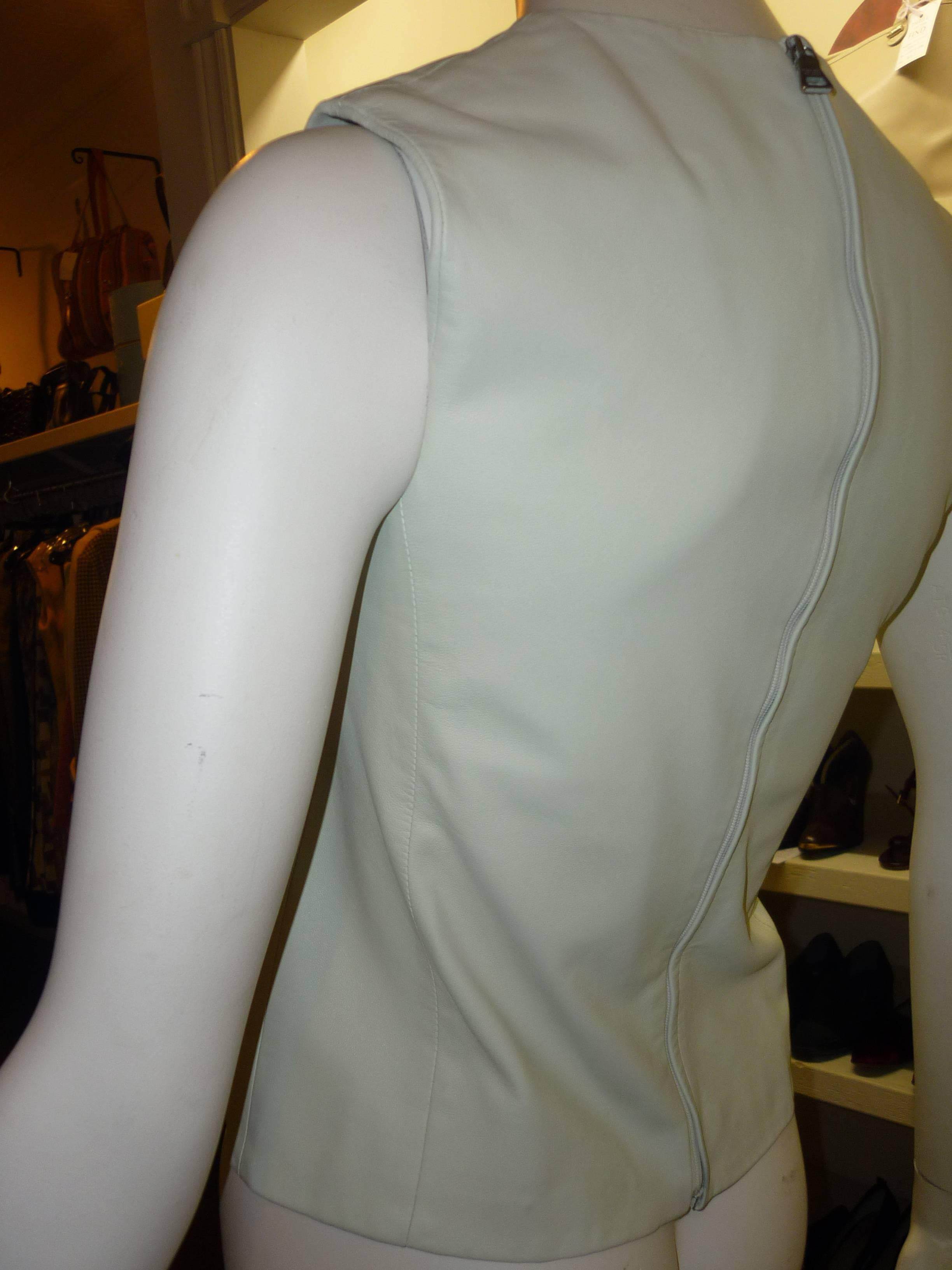 Beautiful and simple this top is fashioned from the softest of lambskin. The color is a very light mint green, and would pair very nicely with pants or skirts. Closure is by way of a top to bottom hidden zip closure.

This top has just been dry