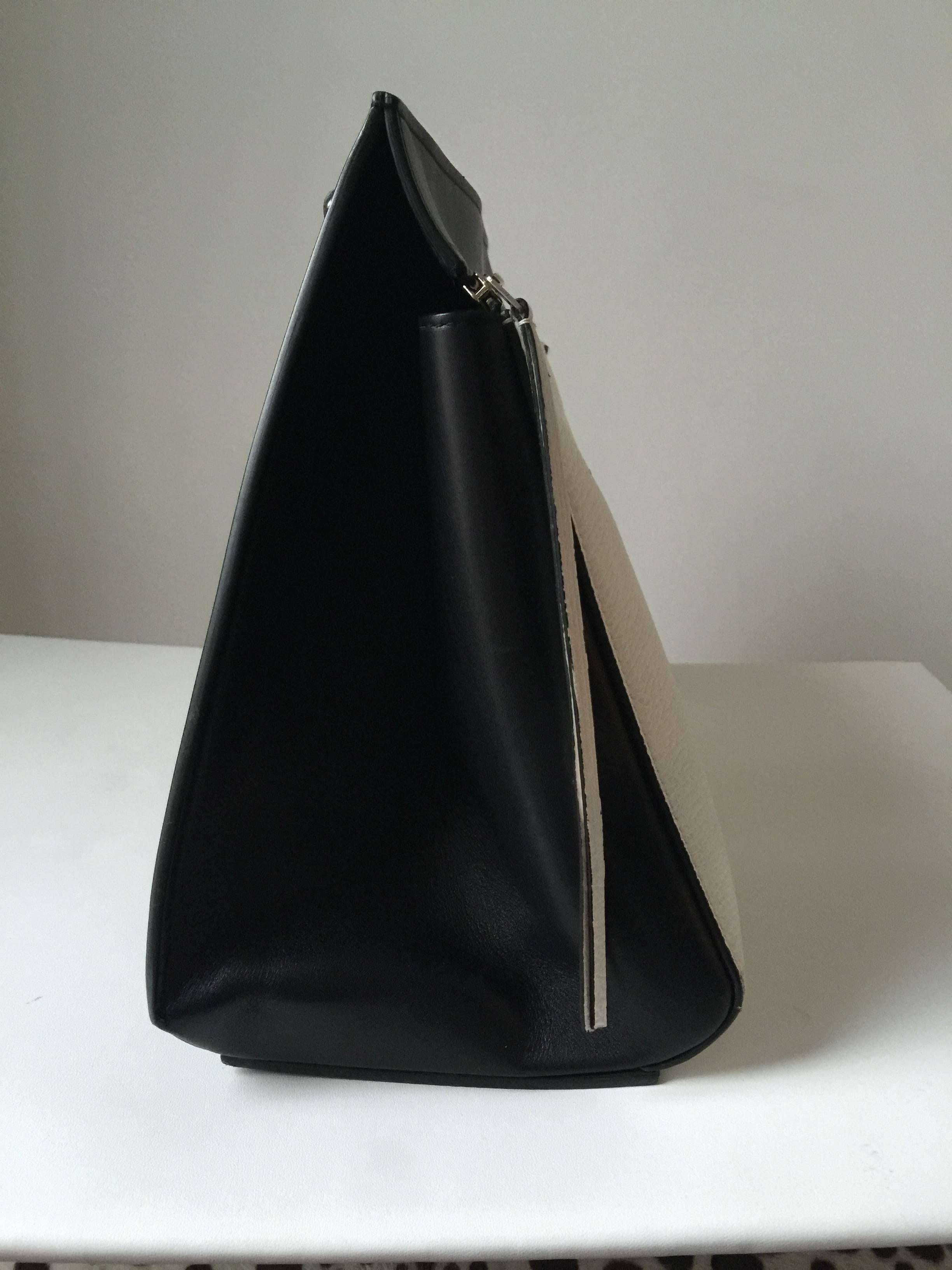 This beautiful two tone Celine bag is from spring 2013.
The inside is fully lined in leather .with interior pouch.
Single shoulder strap and large zipper opening... 13W  x 12H x 7D
handle drop 7.5