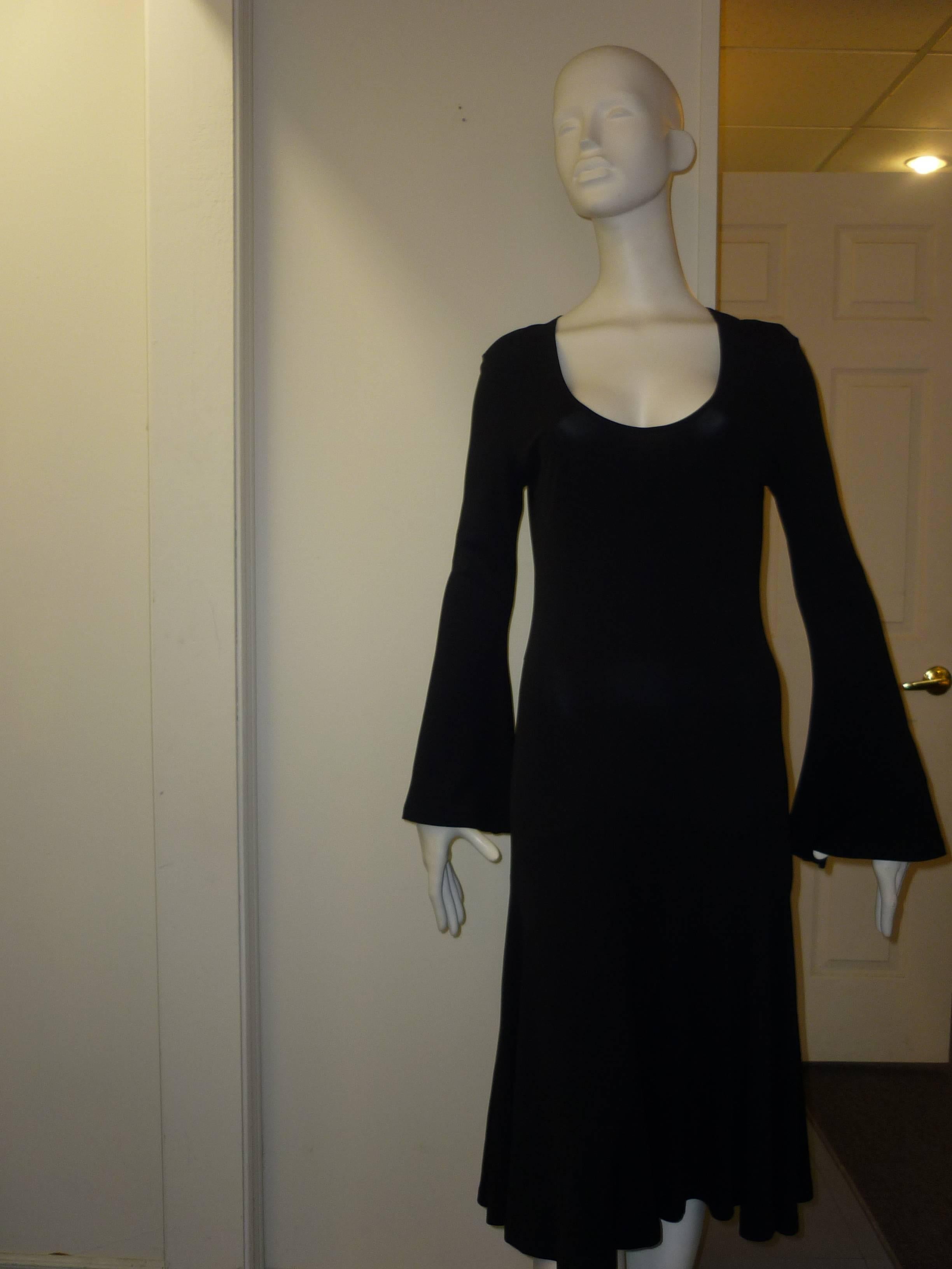 Low neckline angel sleeves and a gaudet skirt make this a very wearable and attractive dress.

The material is rayon with 5% spandex. Made in Italy, this dress was never worn.
