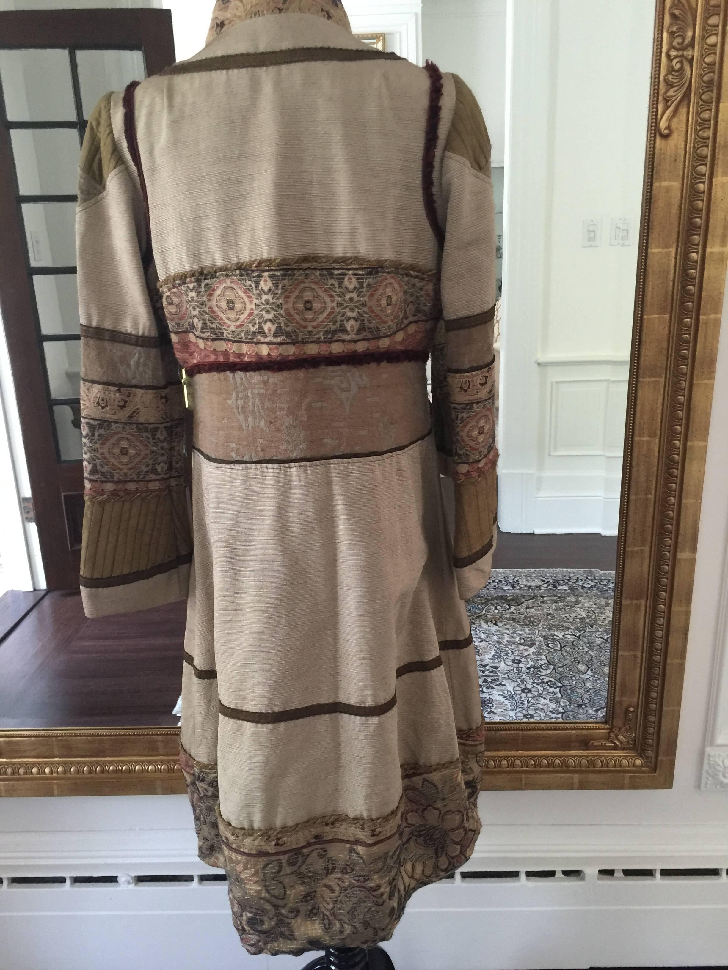 A very unique silk blend coat by Gary Graham, it very boho chic in feeling with its intricate and delicate jacquard trims,
button front with bell decorated sleeves.