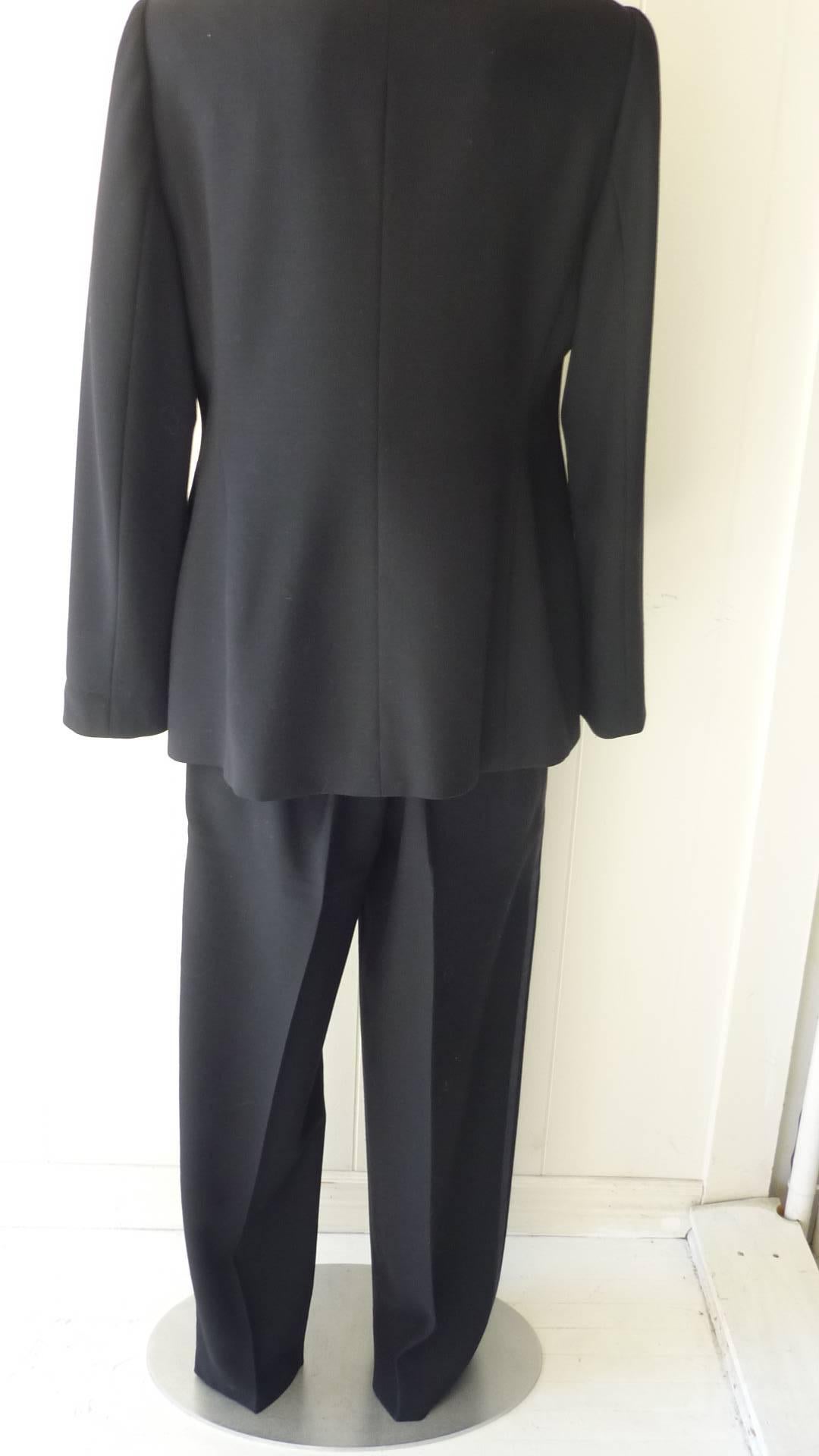Perfect evening attire, this fine wool tuxedo suit has a satin lapel and stripes down the sides of the pants; slit pockets on the pants. The jacket has a one covered button closure and two fake slit pockets.

Measurements are as