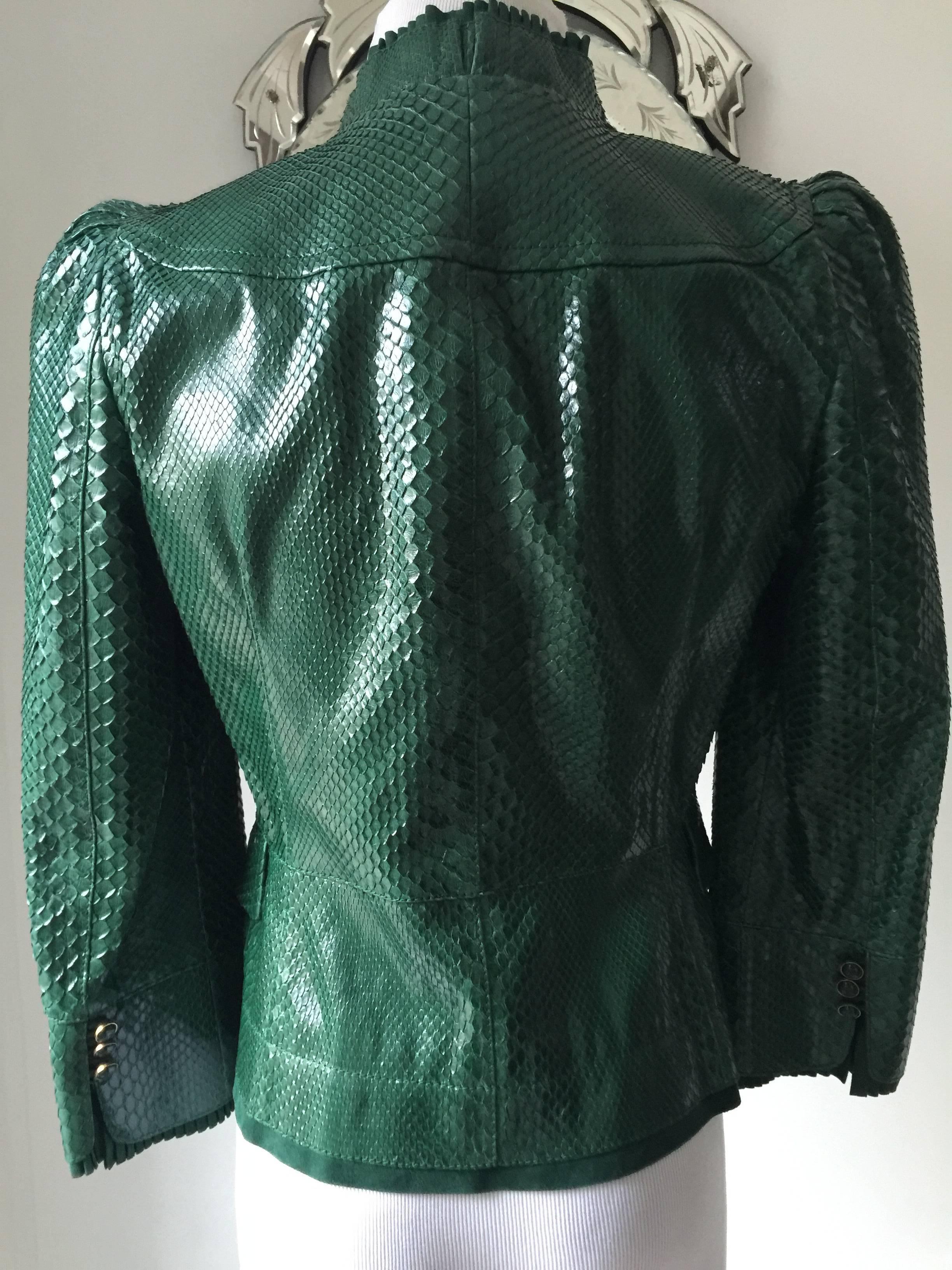 This is a wonderful jacket from spring/summer 2006...
100% python with leather trim and lined in 100% silk...the jacket has a small peblum and a small gold tone belt....collar and sleeves have a knife-pleating  detail in tonal suede...
dual flap