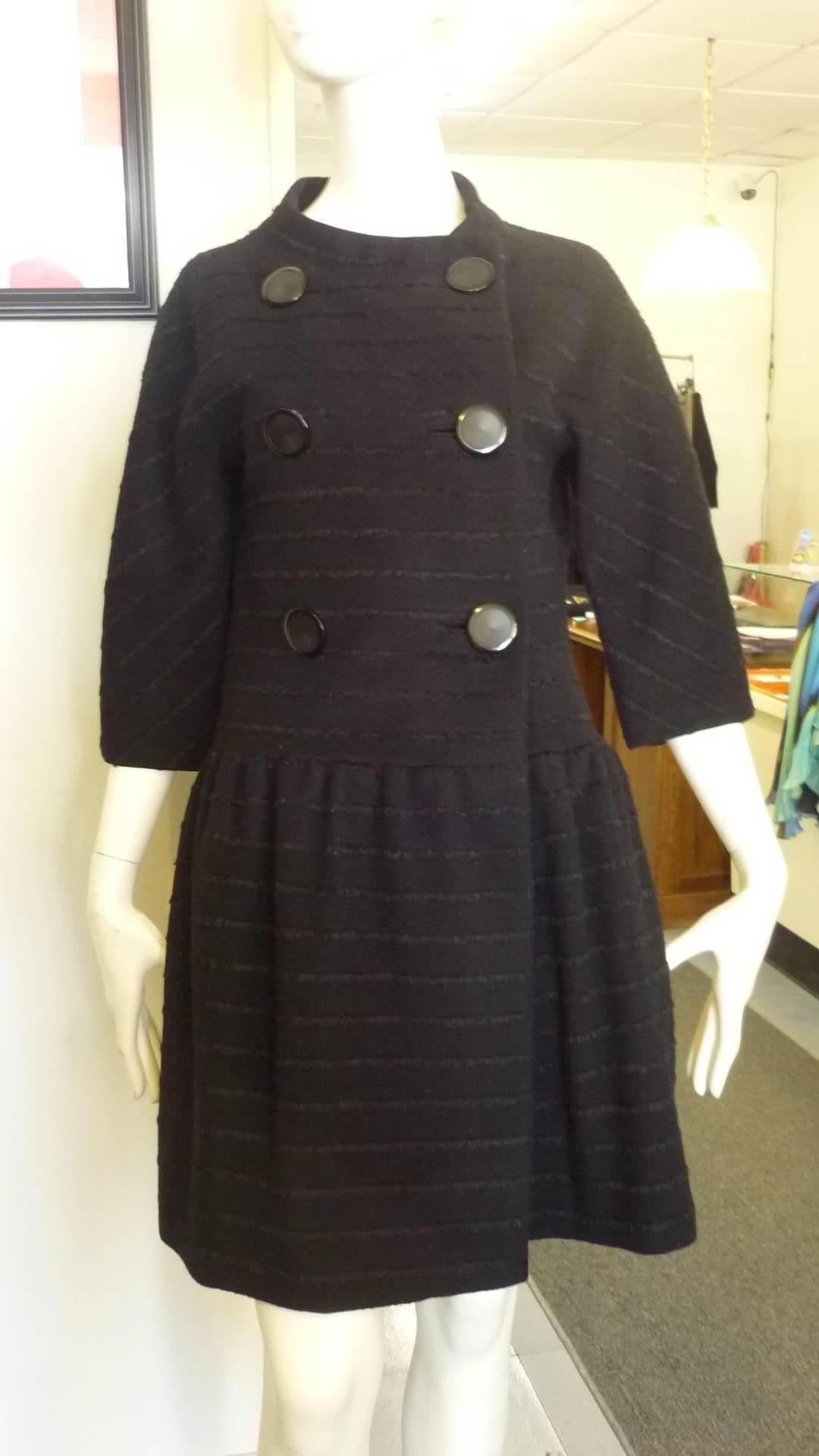 This is a collection worthy coat and it has been marked as in good condition because of small tear in the lining at the armpits. Otherwise this coat is in remarkable condition for its age.

It is double breasted; has a slightly round assymetrical