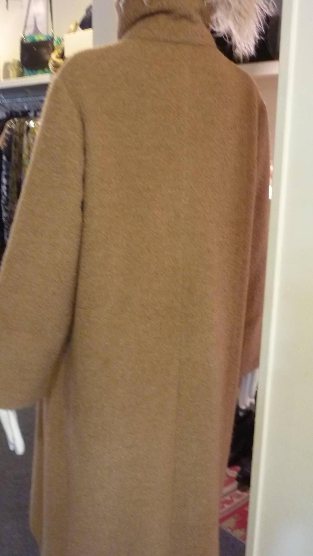 Absolutely gorgeous coat made of 56% Alpaca and 44% virgin wool, with a textured feel. The funnel collar has two button and there are two slit side pockets.

The coat is marked 4 US but it is a generous coat. Please look at the actual measurements.