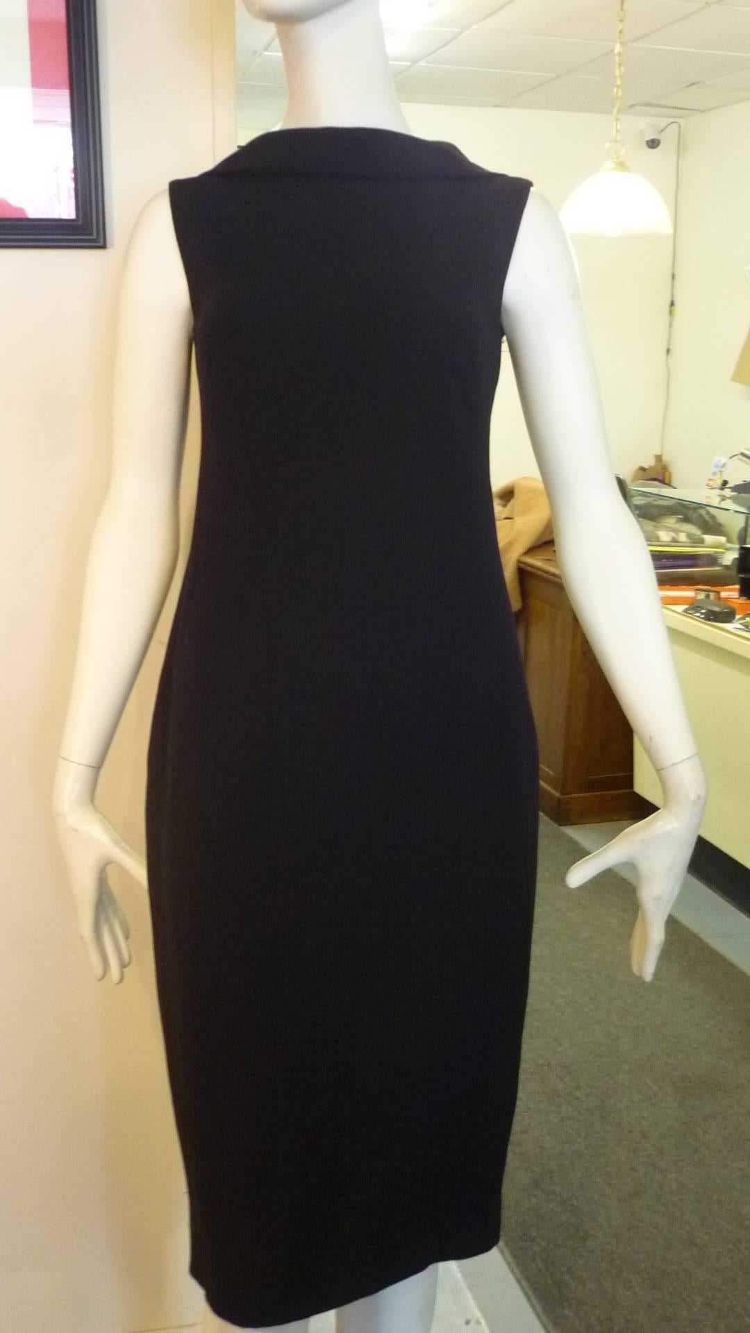 Such a wonderful dress which would be a staple LBD. The juxtaposiion of the high front to and low rounded back, couple with the discreet darting at the bust, and the hidden back zip closure.

