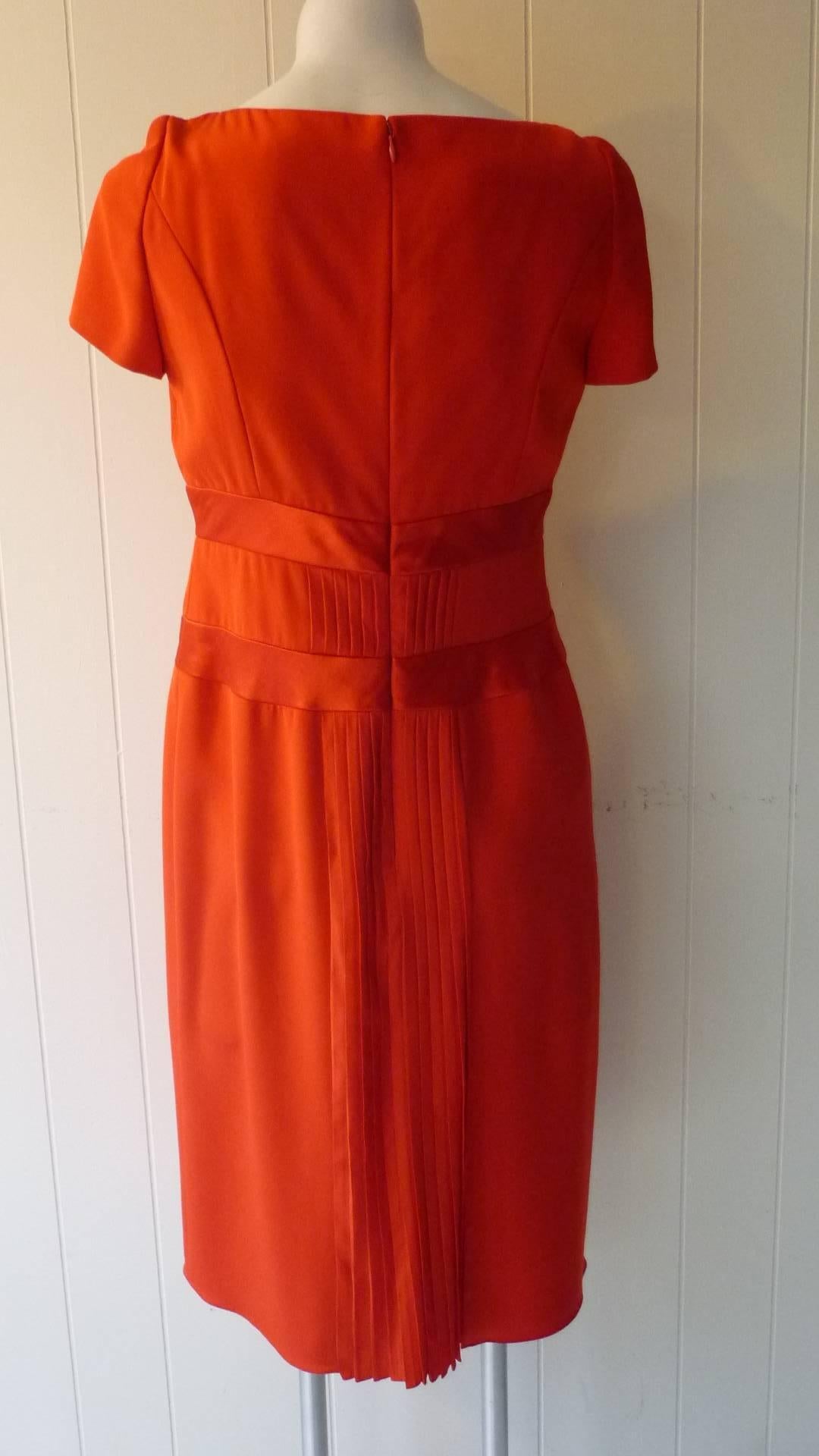 Looks like a simple dress but has wonderful details such as satin waist banding;  pleats at the back, and darting.