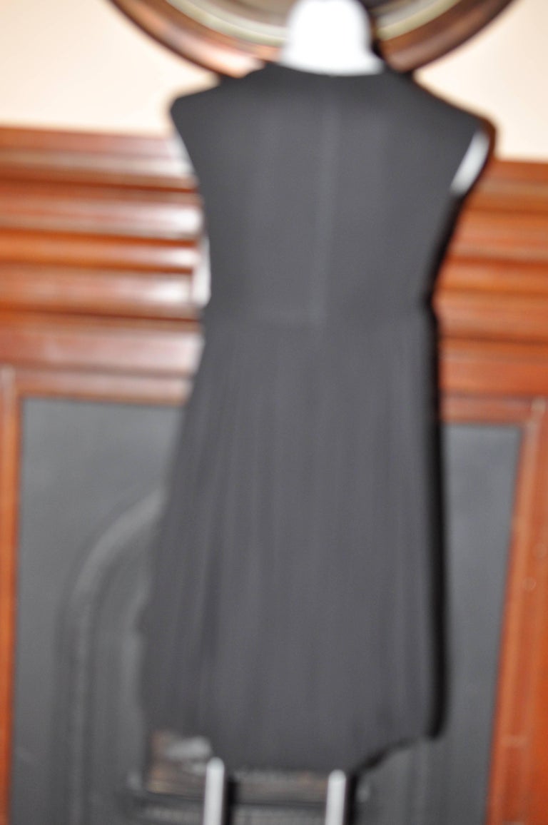 Perfect rayon LBD with a nice weight; cap sleeves, and a low cowl neckline.