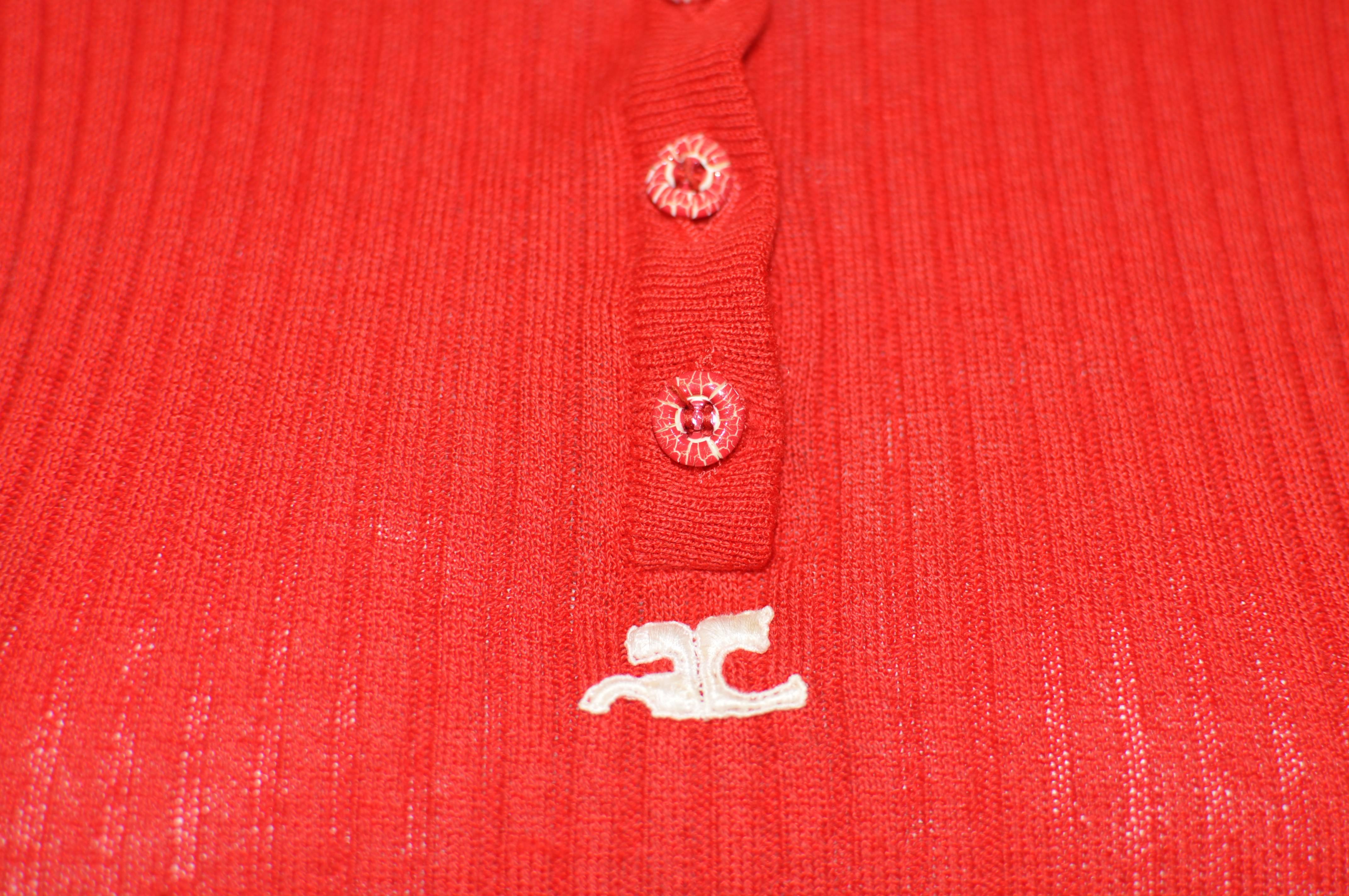 The set comprises of a short sleeve sweater with round neck and four striated (red and white) buttons. The v-necked cardigan has five striated buttons and two pockets.
Both pieces sport the iconic white Courreges logo; have a spare button; wide