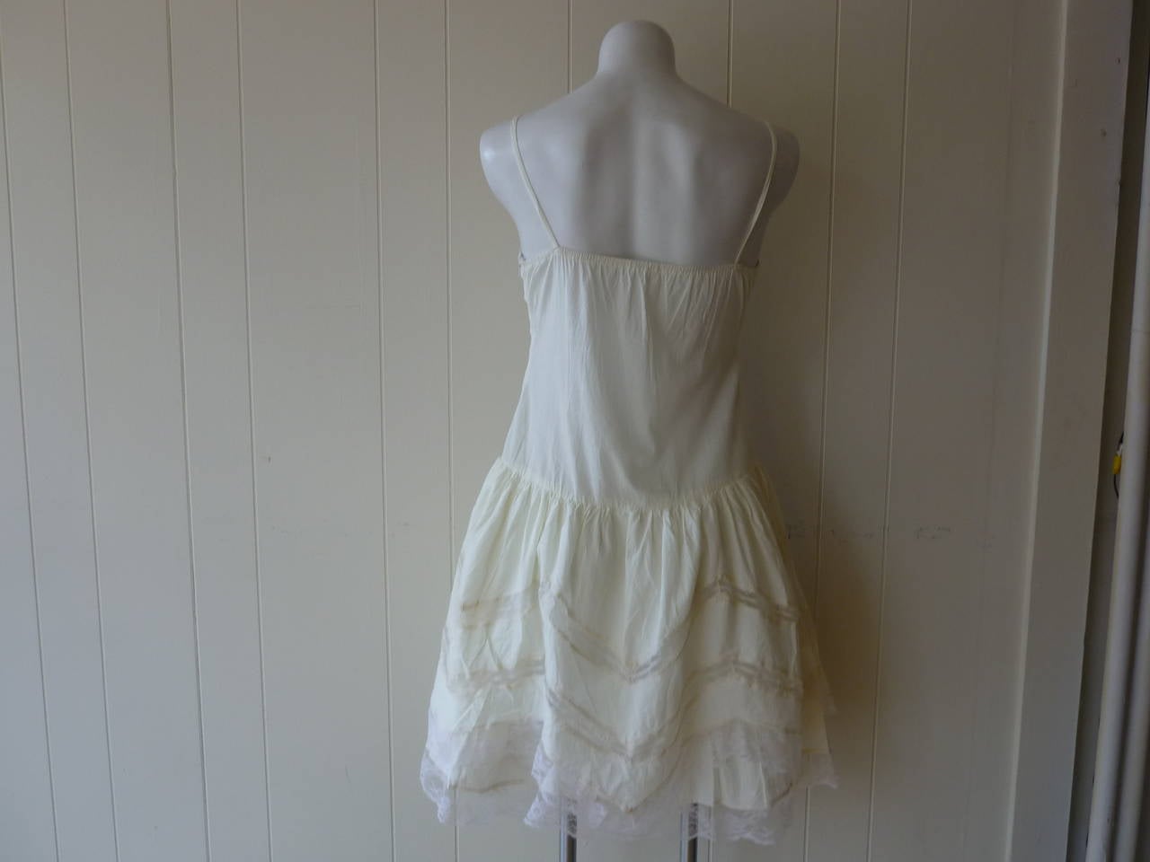 Ivory cotton dress with a drop waist and lace around the bust line as well as the skirt (two layers). Wear it to a garden party or dress it up for dinner!