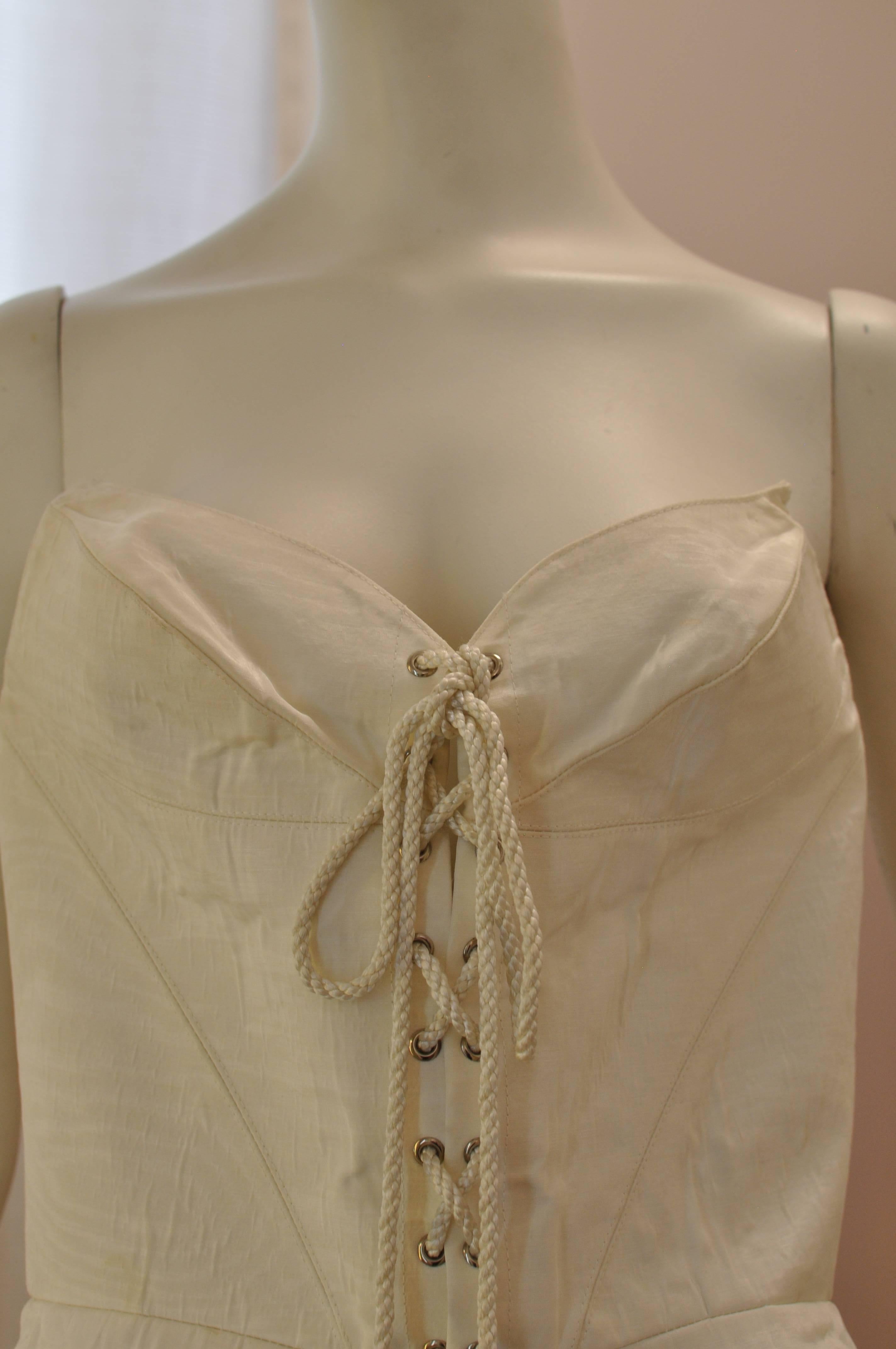 Typical of Mugler's designs; pointed edges; interesting darts and pronounced angles. This cream colored/ecru bustier is  laced up in the front with metal pointed anchors, but also has a back center zipper. It is in far condition as the