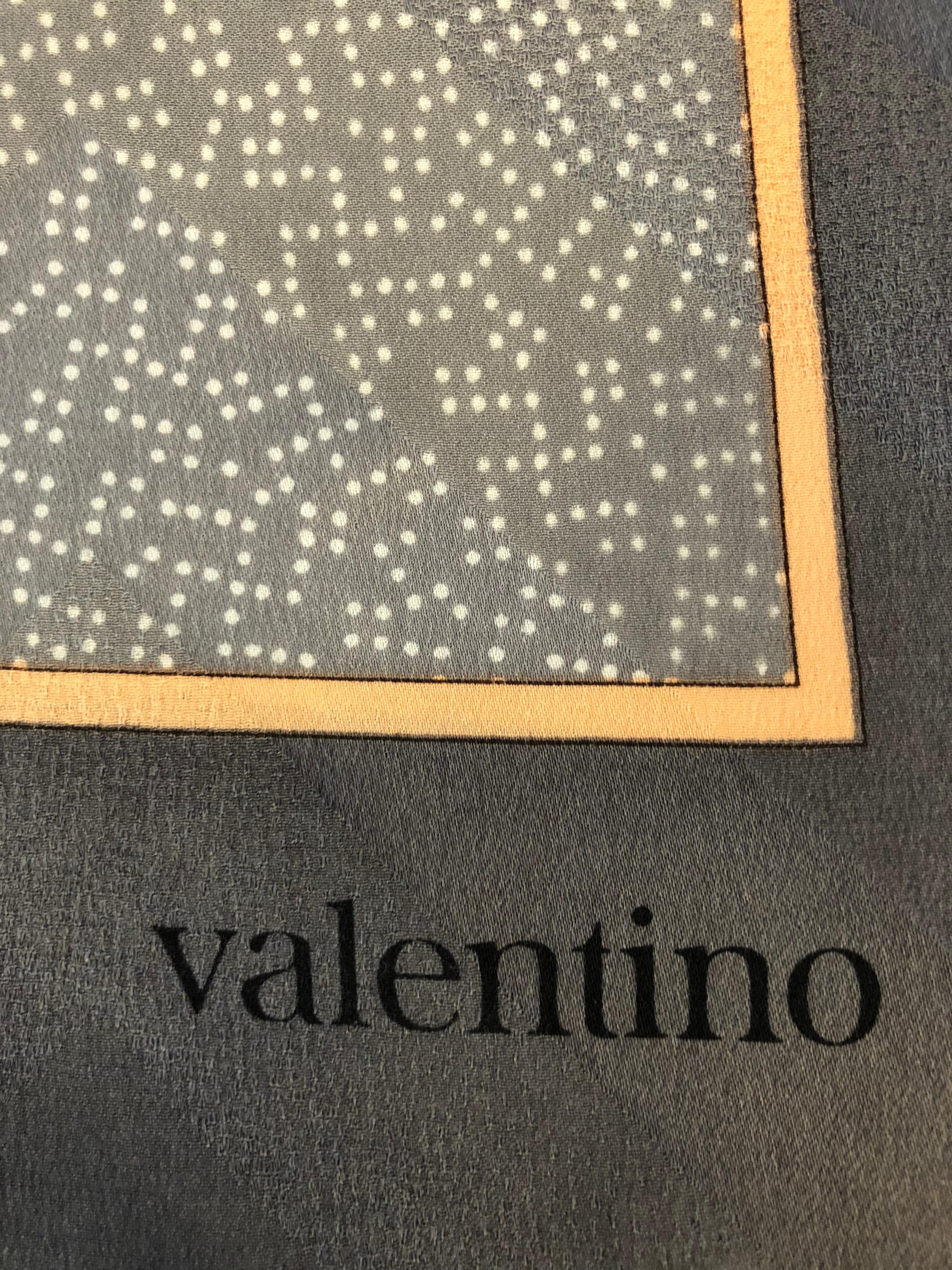 Beautiful Valentino silk scarf with interesting prints such as chevron background throughout; floral (I think from the Fritillaria family); white specks on a grey background and plain pink chevron bordered by a thin orange band followed by a wider