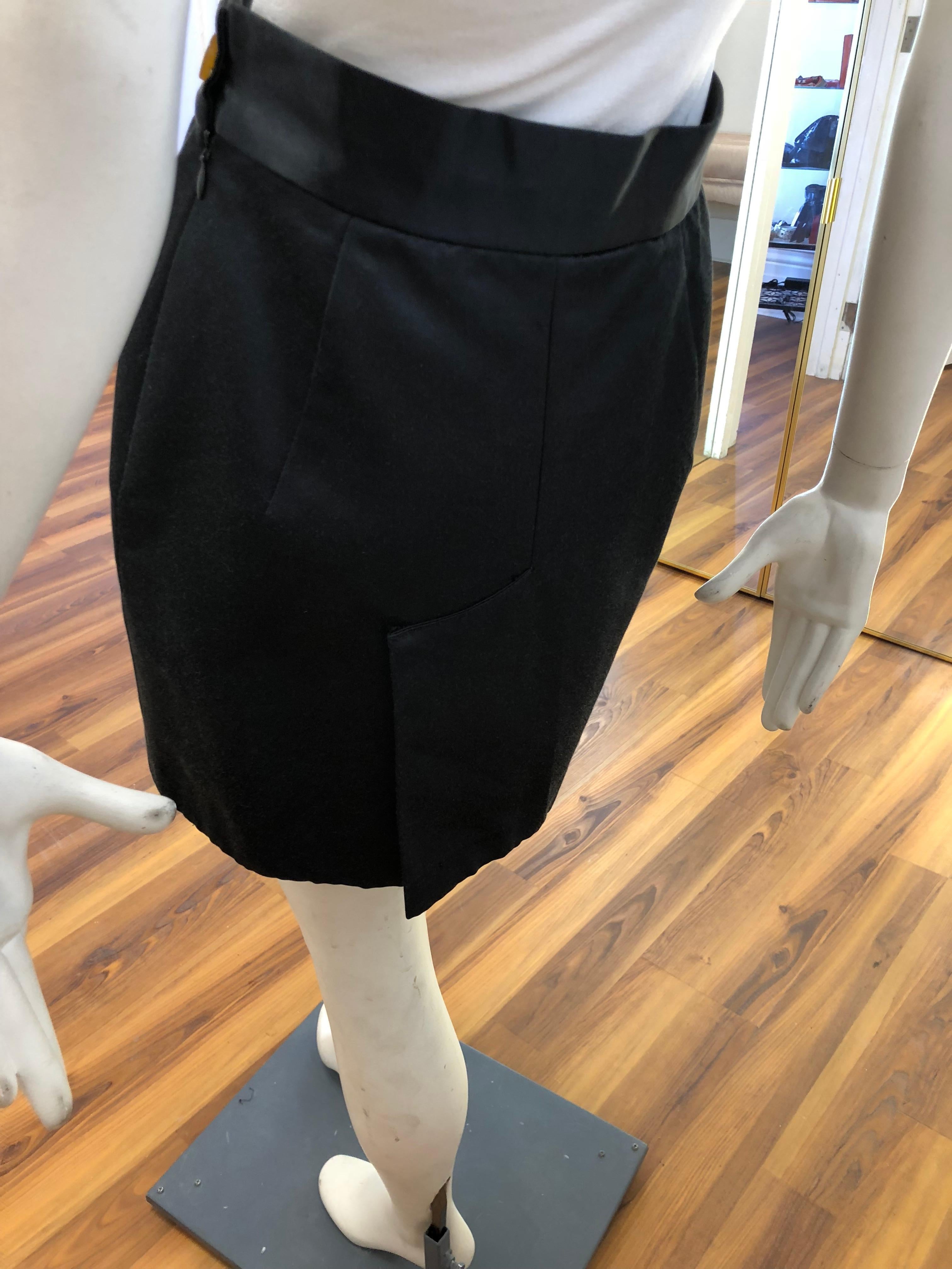 This Vivienne Westwood mini skirt is made of 65% cotton and 35% viscose and is quite plain at the front, but in the usual Westwood style has an interested back slit, and of course the iconic button. The Max Mara top comes free with the skirt.
