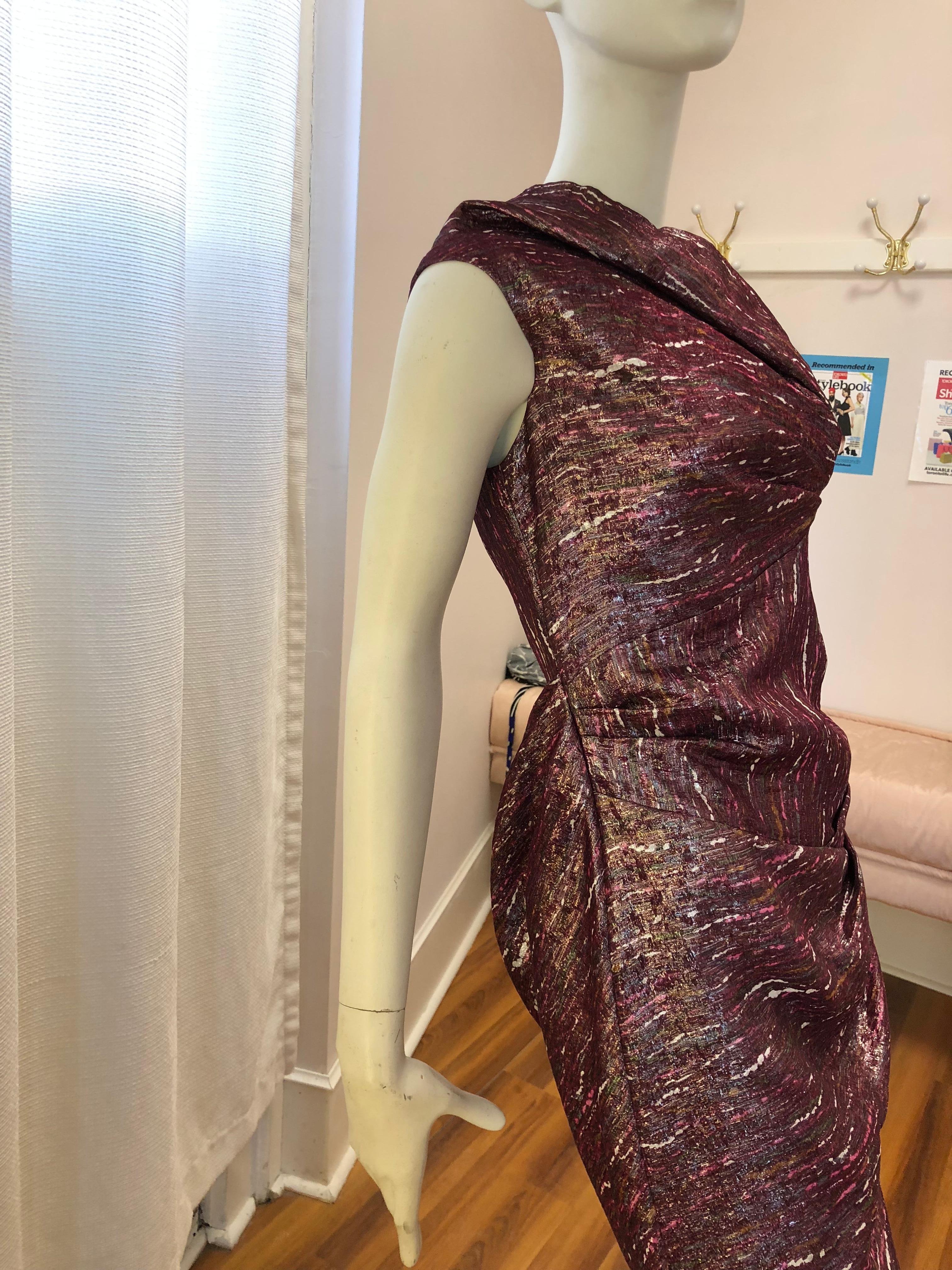 The blend of mainly silk with a bit of polyamide and metallic fibers give this dress a wonderful shine. There is draping back and front, and includes the neckline.

The lining is 100% silk and dress is very light.