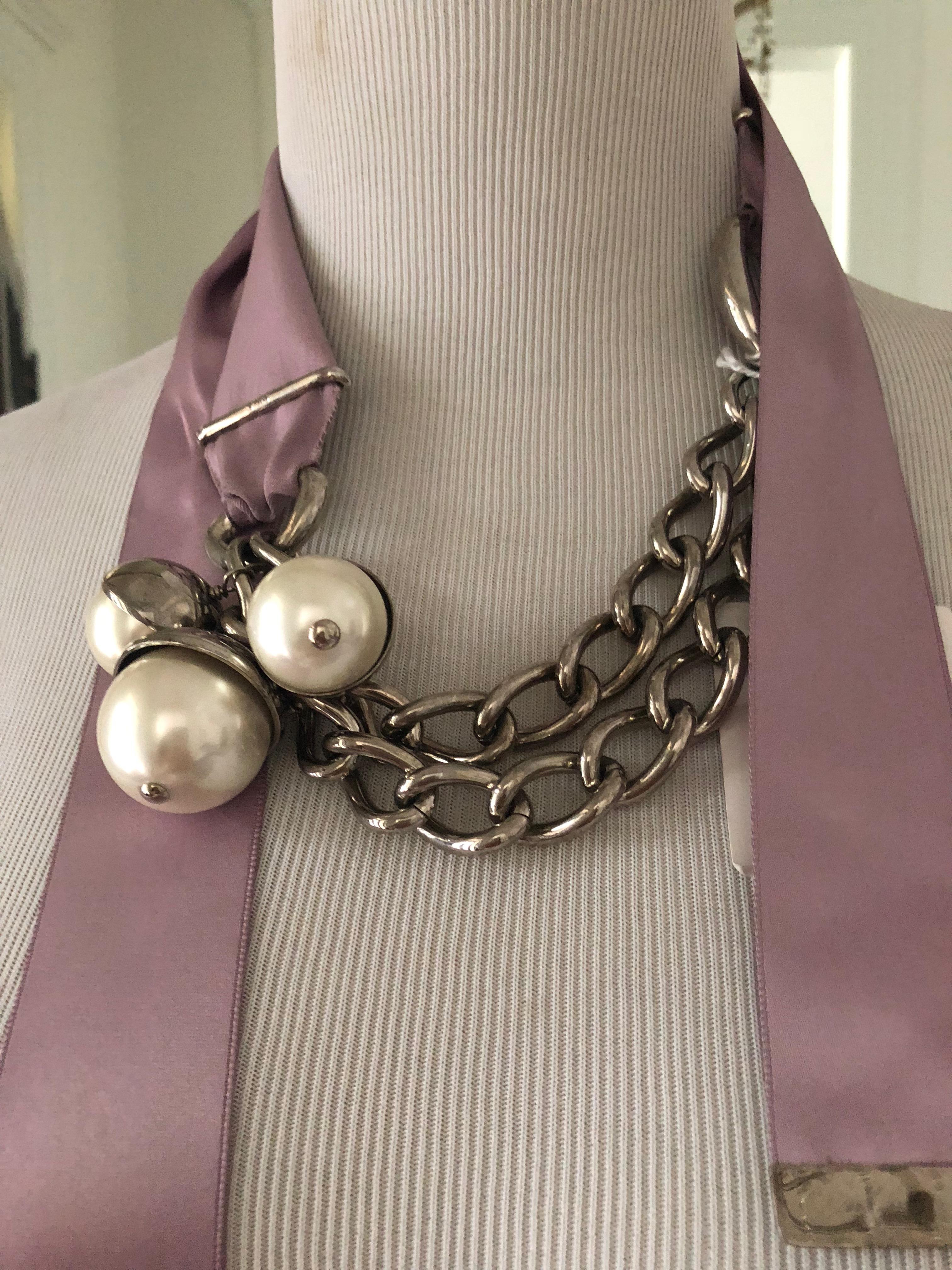  Never worn, still in it's box this is w beautiful statement piece.
Can be worn as a belt or as a necklace, chain with big faux pearls and a feminine pink satin ribbon as closure.