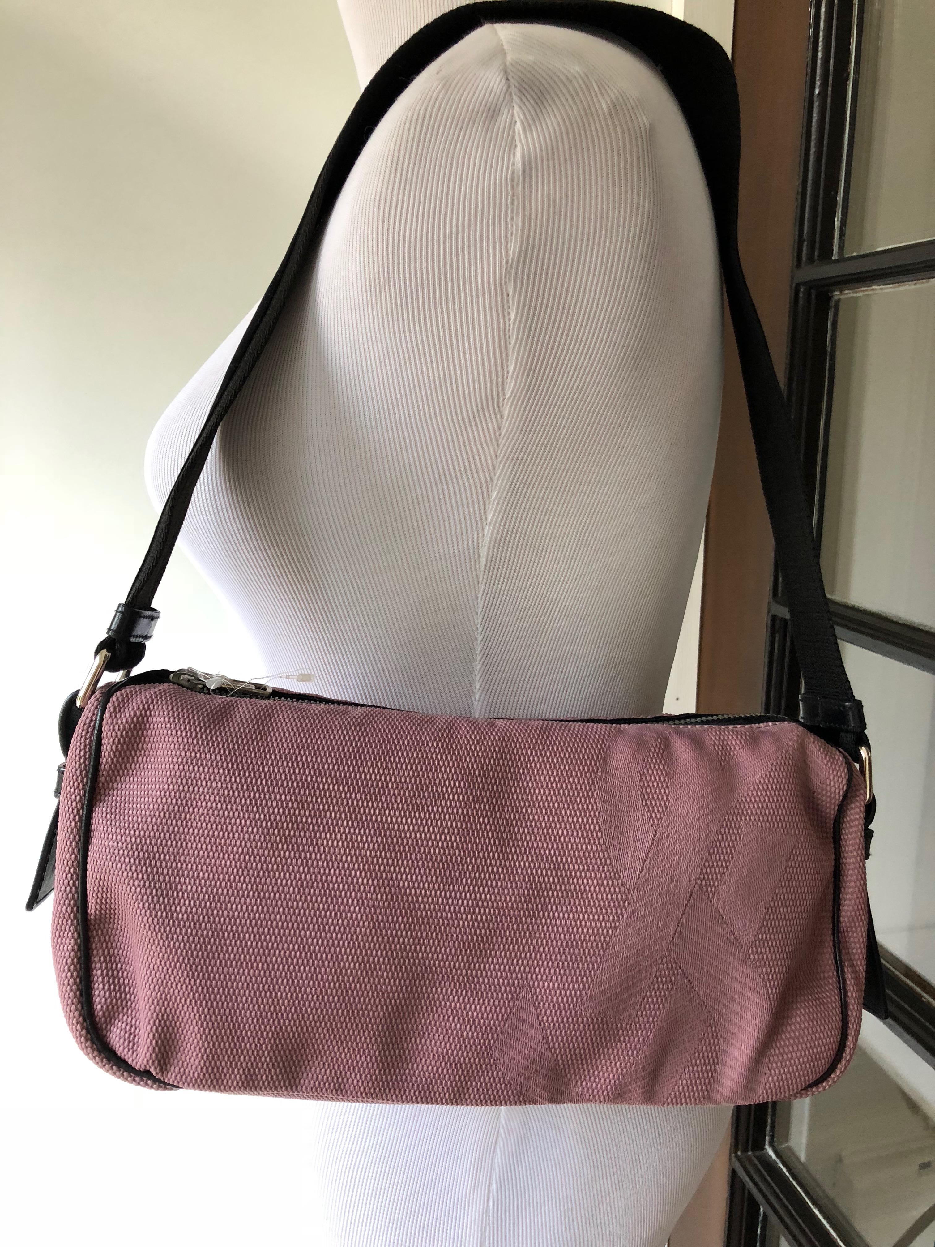 Dusty Rose cotton canvas bag by Yves Saint Laurent Rive Gauche.
With black velvet trimmed zipper.
 Shoulder strap is also in black velvet.
This unusual combination adds style to the bag.
Tabs are in leather, lining is in coated cotton.
Bag measure