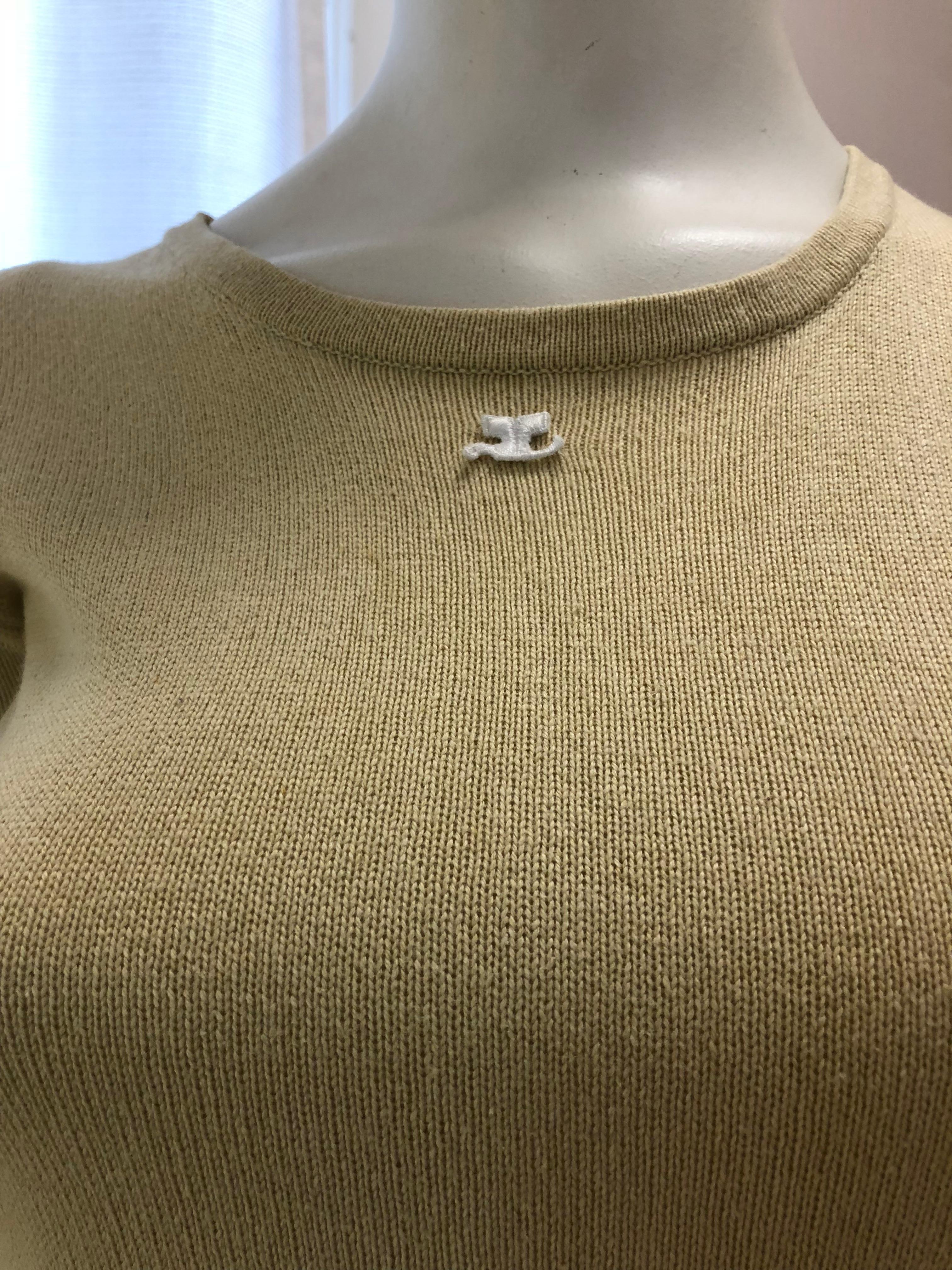 Nice simple top in a beige with yellow tones. The piece has ribbing on all the extremities and although only 15% cashmere is very soft. Right below the round neckline is the iconic Courreges emblem.