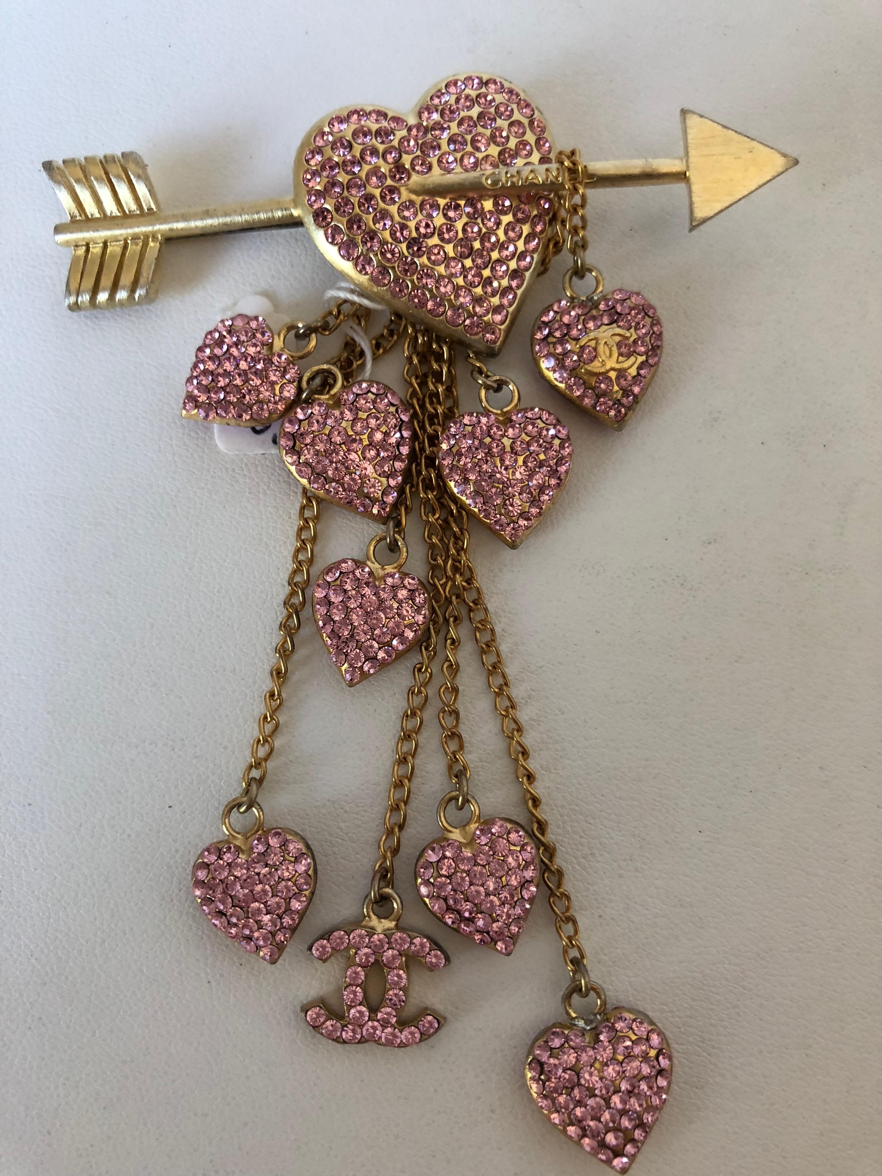  Rose Gold Tone Chanel Pin with a cupid arrow ...staggered dangling 
rose gold and crystal pink hearts ....