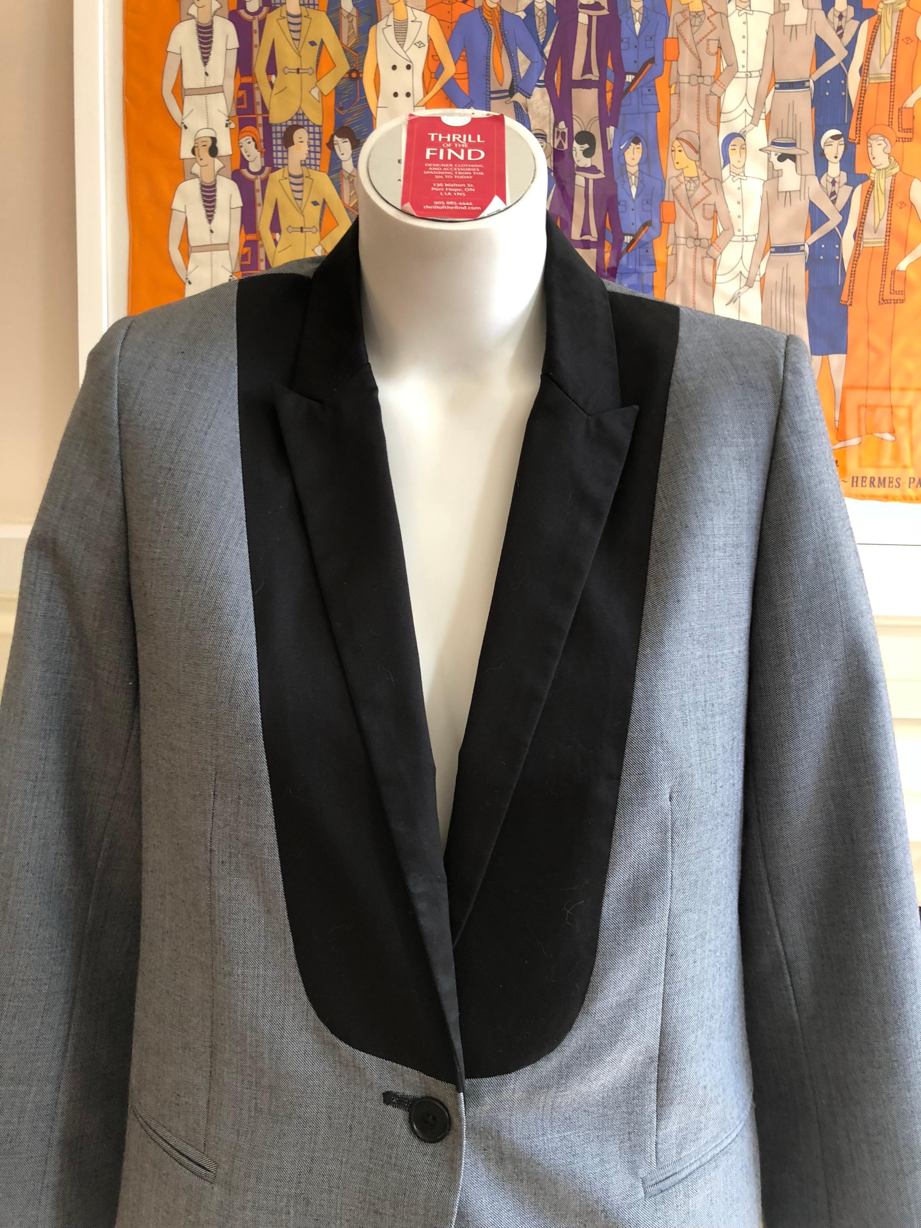 Grey with a black bib, the jacket is made of 55% polyester and 45% wool. It has a one button closure;  two fake slit pockets; five buttons on each cuff and two side vents at the back.

Wear it with a nice pair of jeans or pants/skirts.