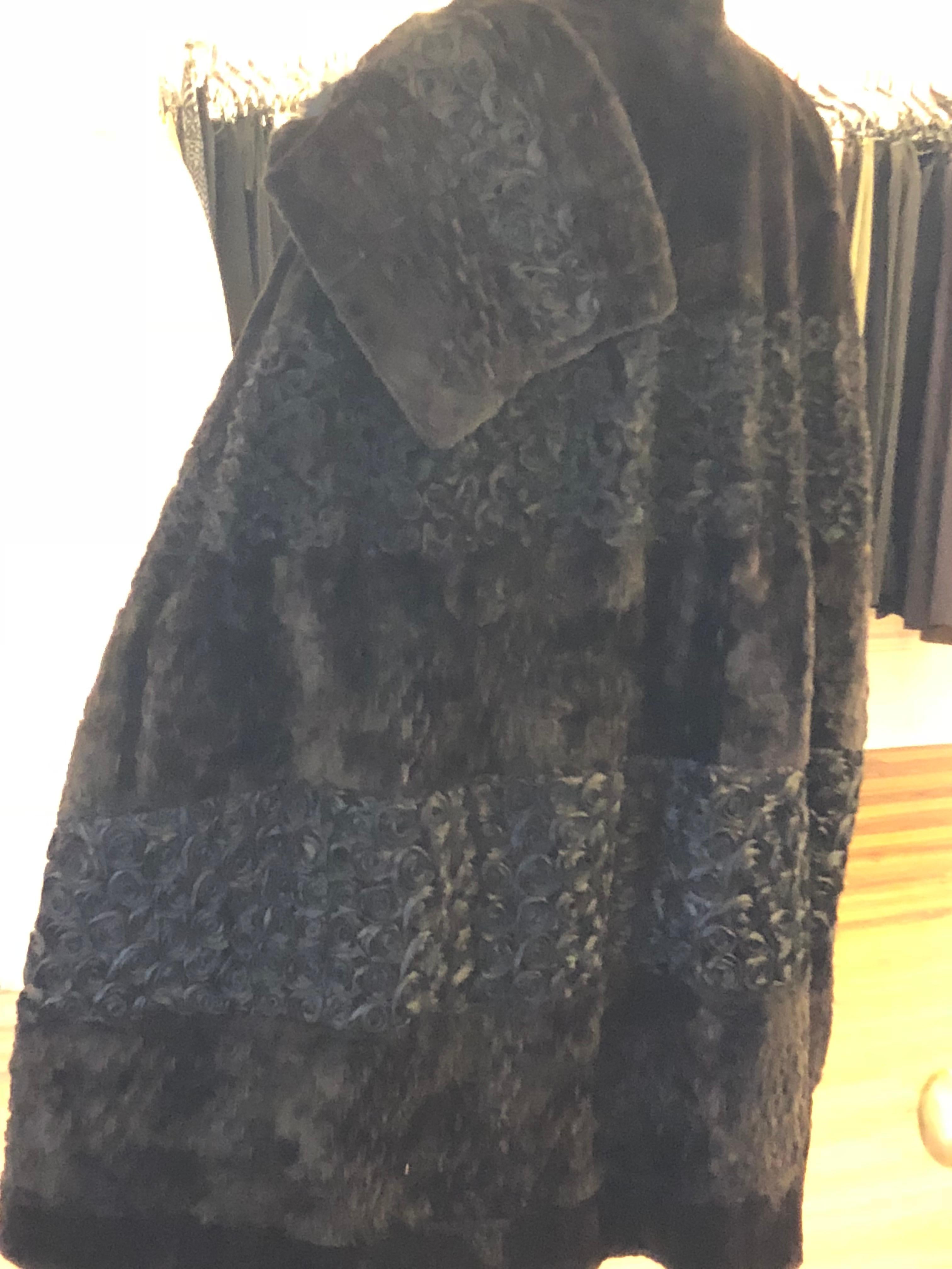 I believe this a sheared mink cape, but could be chinchilla. The hand work is magnificent combining weaved fur; organza flowers, and fur pelts. The same combination is replicated in the over the shoulder attached shawl scarf which is embellished