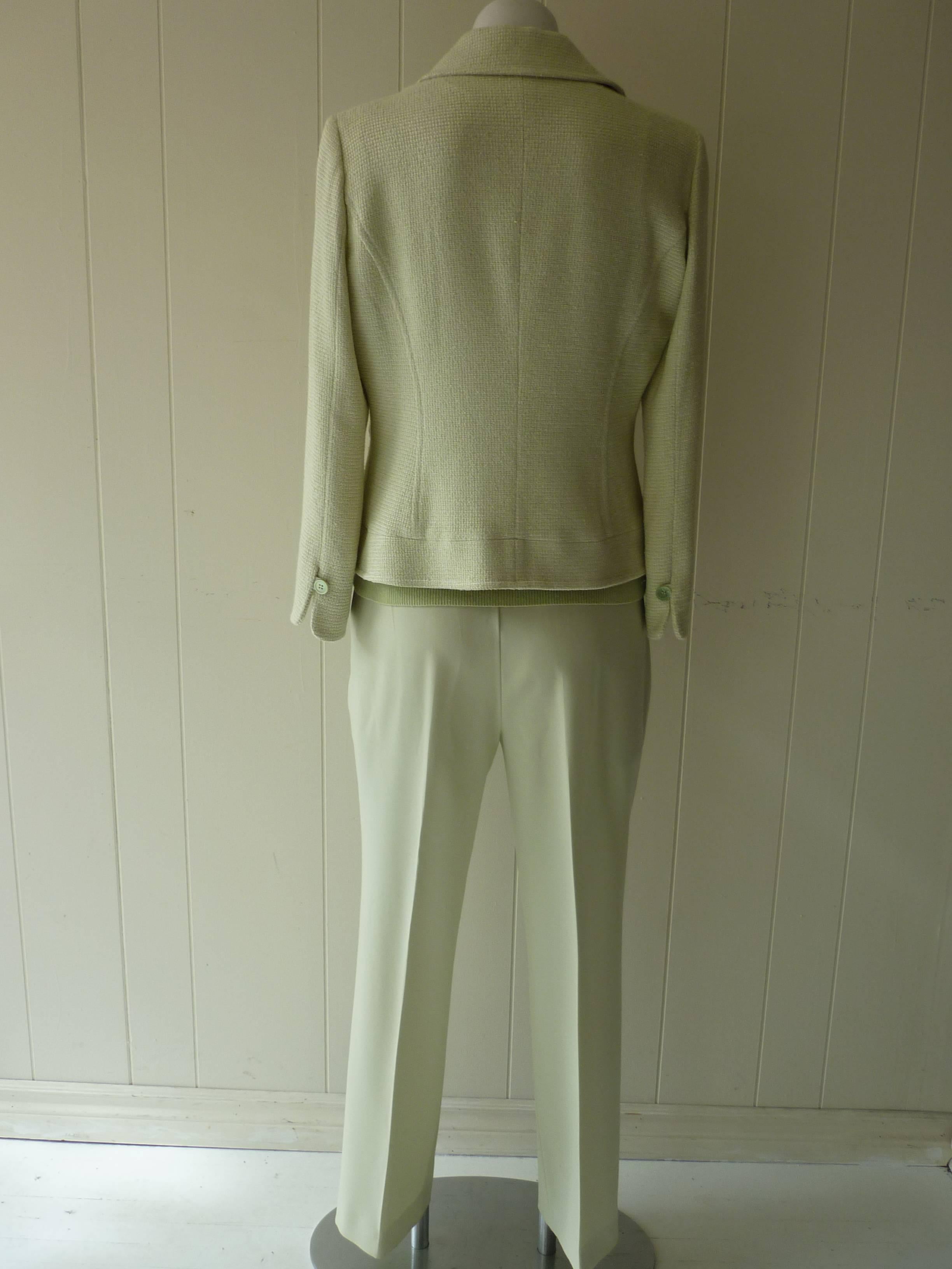 Exceptional suit! The jacket is made of weaved cotton and virgin wool with a silk lining; the pants are a light wool, and the sleeveless top is cashmere.

The jacket is a size 44 (Itl); has 2 flap pockets; the button holes are trimmed in a