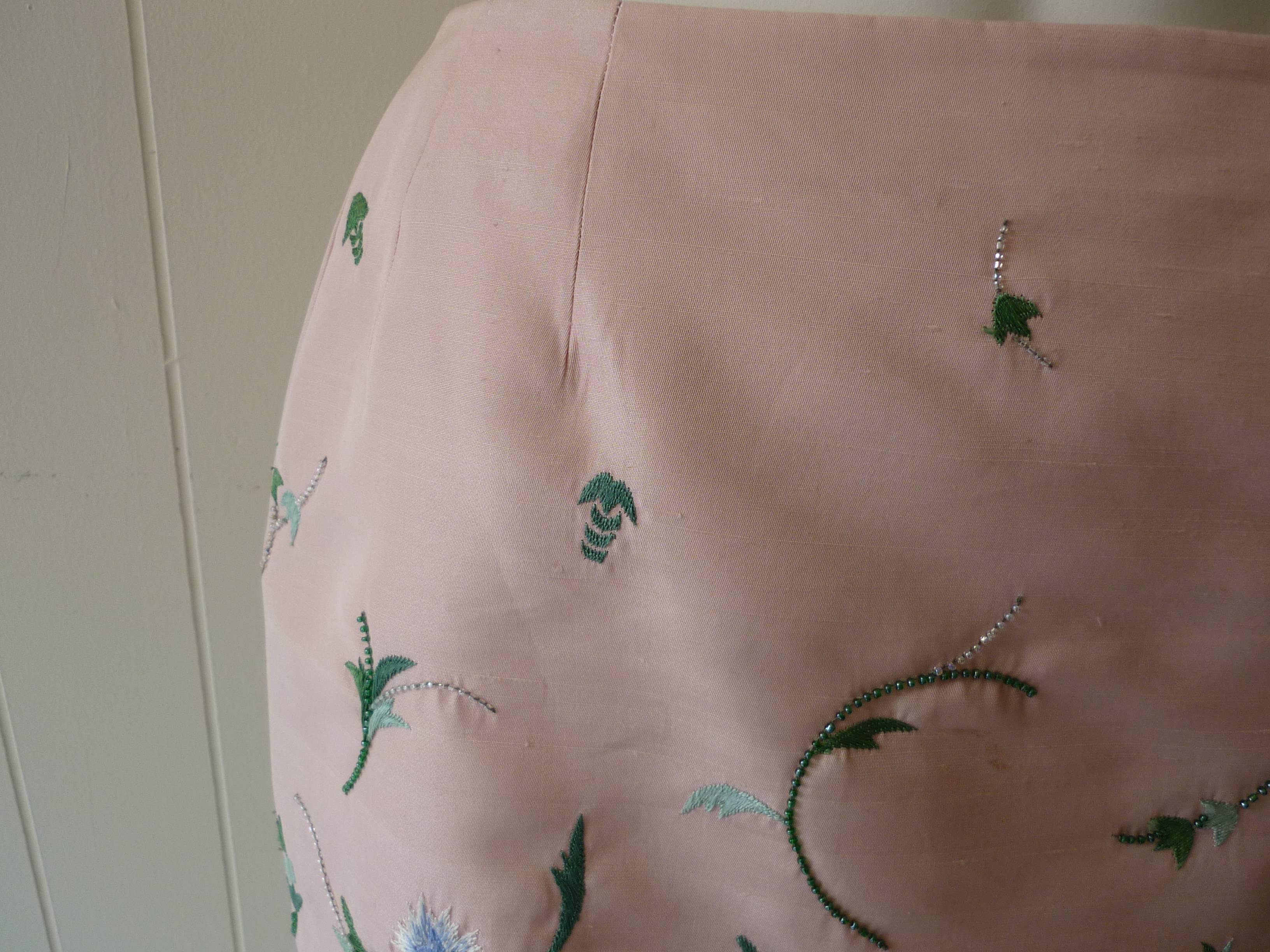 Such a nice evening skirt it is made of a lovely pink raw silk and embroidered with silk thread in the form of leaves and floweres which are embellished with seed pearls.

The hem of the skirt is embroided as well with seed pearls circling the