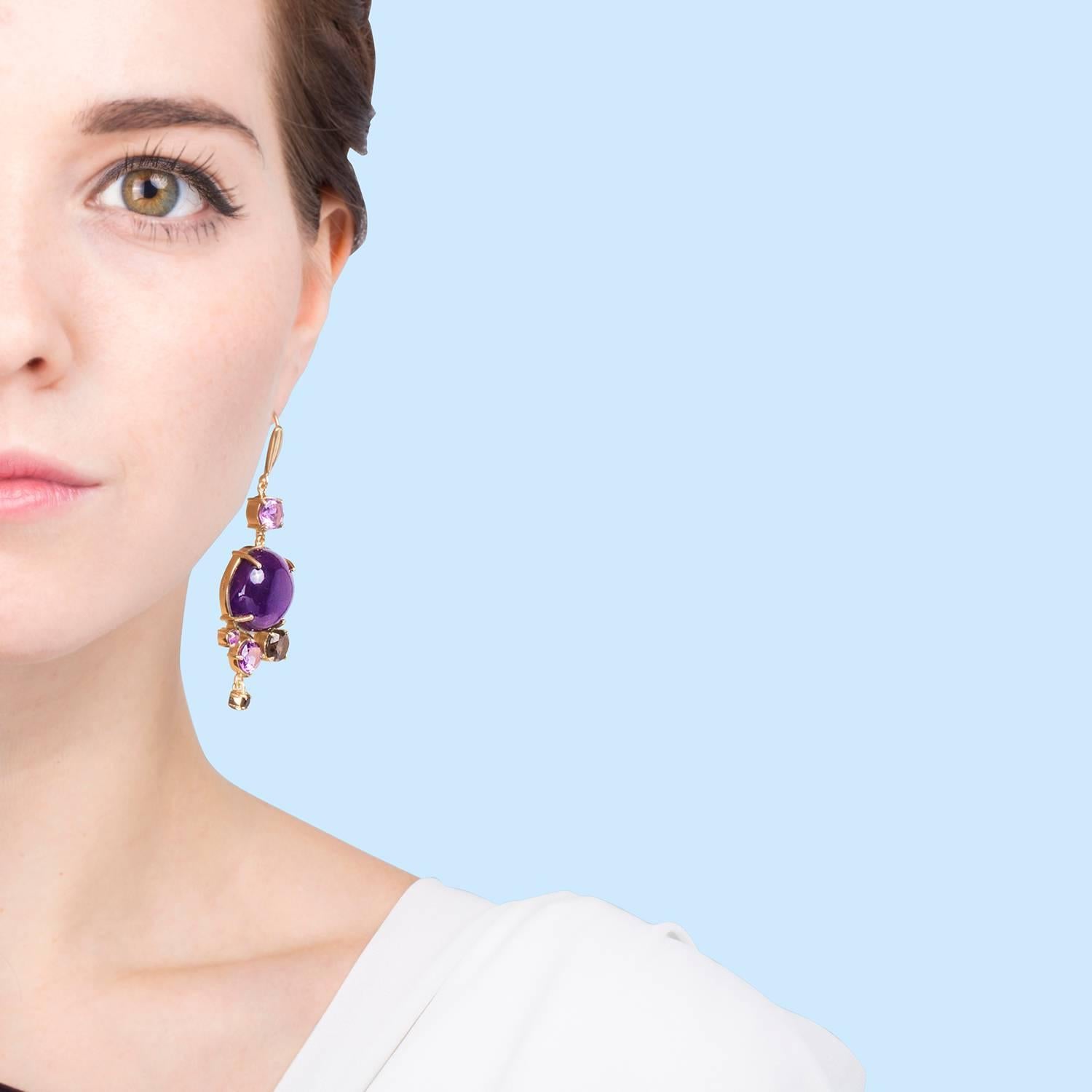 Unexpected combination of colours. Amethyst and smoky quartz combining cabochon and facet cut in these statement earrings for a more formal occasion.

18kt gold vermeil on rhodium plated silver. 2.5 micron plating.
6.5cm in length and 2cm width