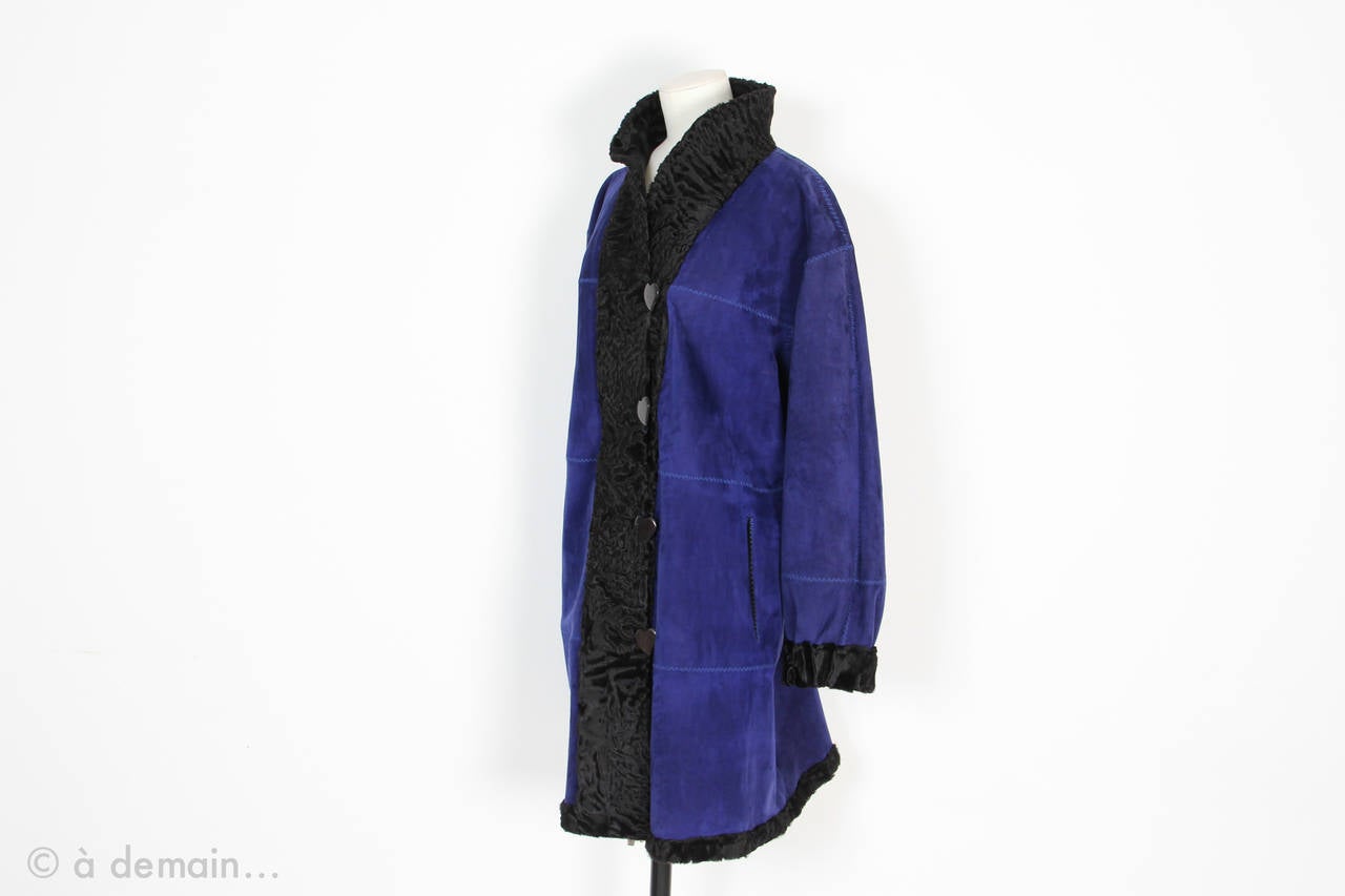 Yves Saint Laurent Fourrures Coat reversible made of black astrakhan on one side and neon blue suede leather on the other side. Pretty buttons shaped as hearts. 2 Pockets (with black astrakhan reverse on the blue side).
French size around
