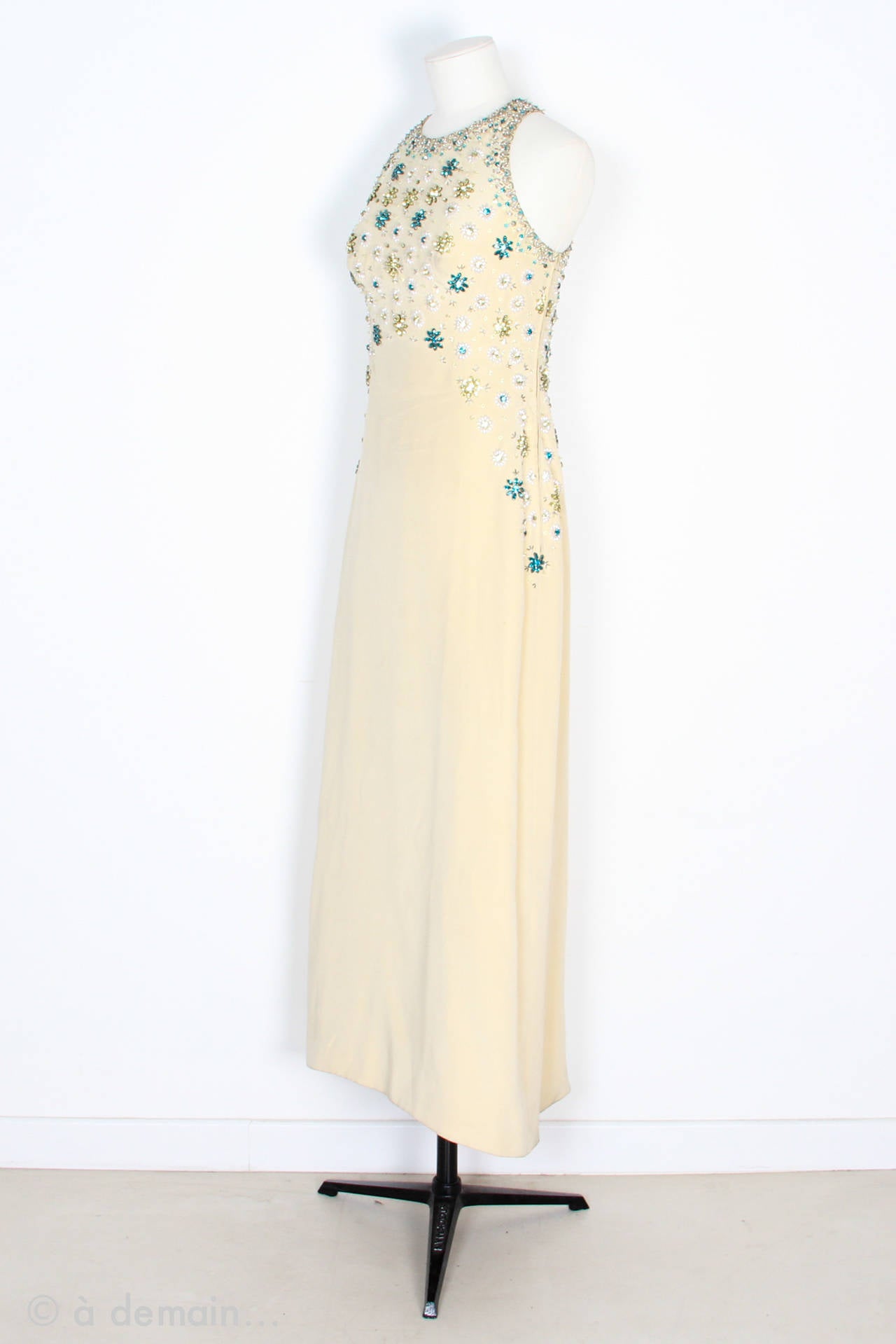 Gorgeous Evening Dress designed by Marie Clouet and beautifully embroidered by the great French Fashion Designer François Lesage. From 1963.
Very pretty drape which falls perfectly and straps crossed in the back hung by a little inside press stud.