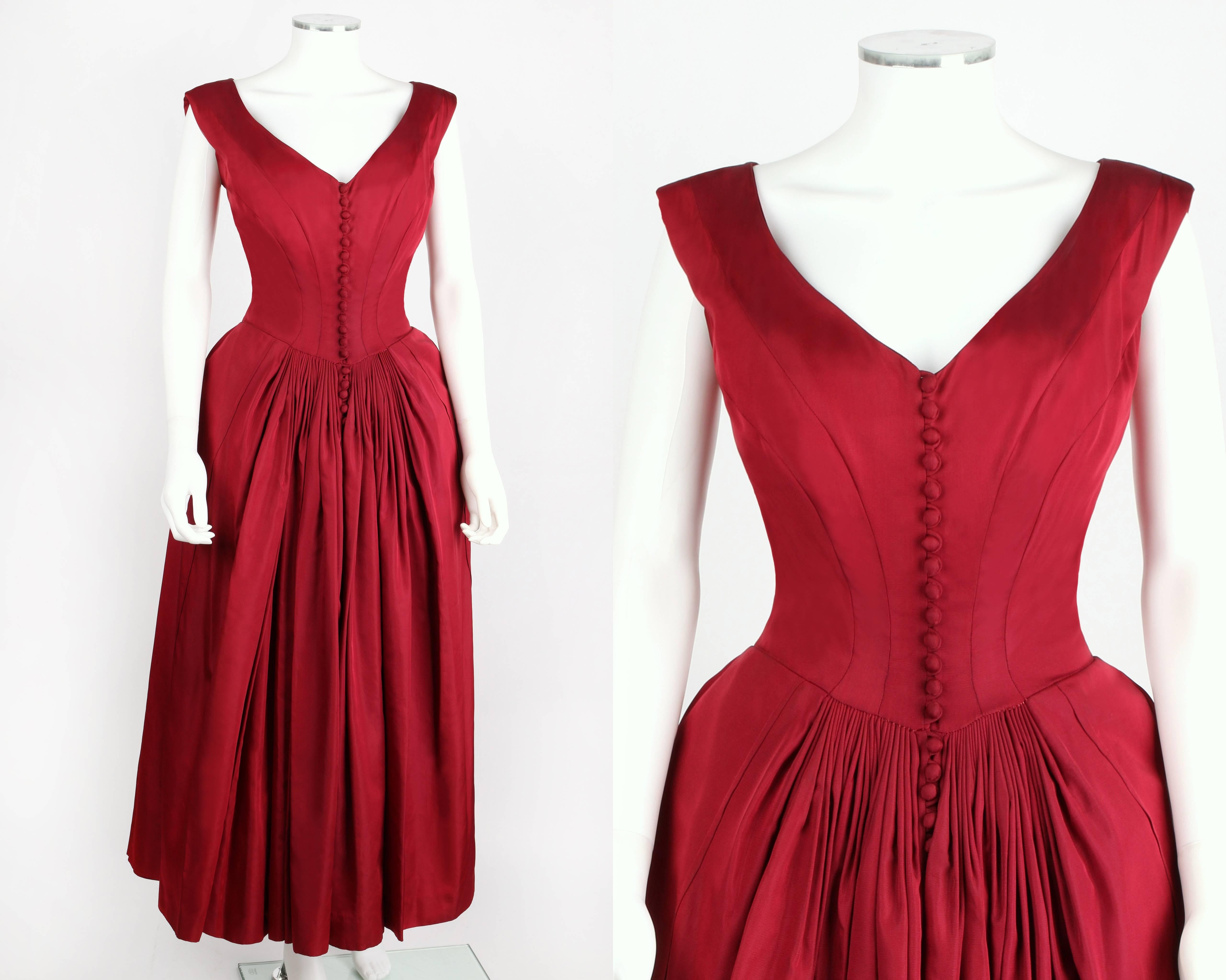 Rare and important Nettie Rosenstein circa 1949 red faille evening dress.  Likely an Eva Rosencrans design, this gown is New Old Stock with original tags and a packet of buttons still attached. Dress has a low v-neckline at front and sits slightly