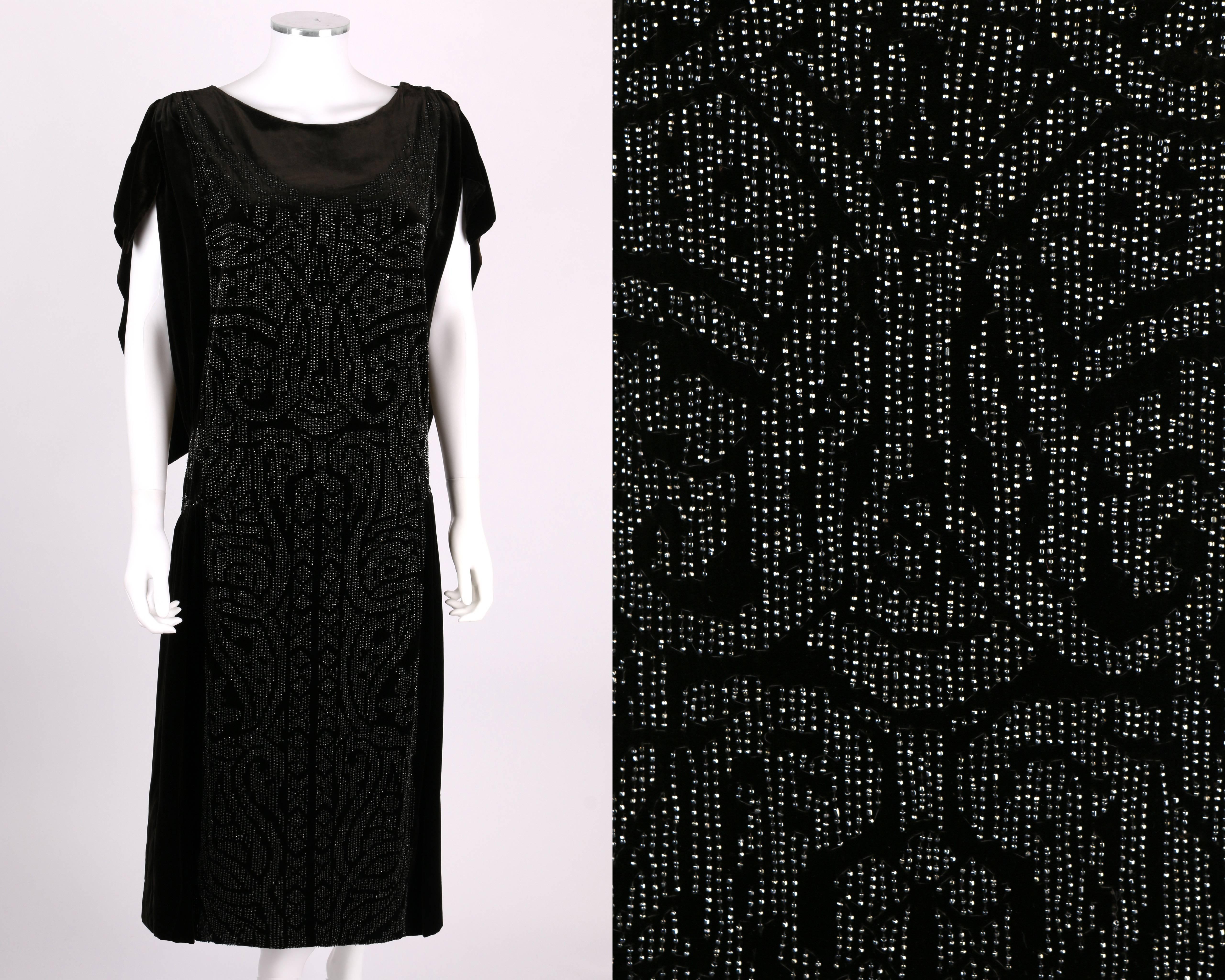 Vintage circa Fall 1922 Adair Paris - Franklin Simon & Co. Fifth Avenue black silk velvet evening dress.  Classically inspired beading.  Cap sleeves with cutouts at shoulders.  Cape-style back.  Snaps at shoulder.  Please note that this item was