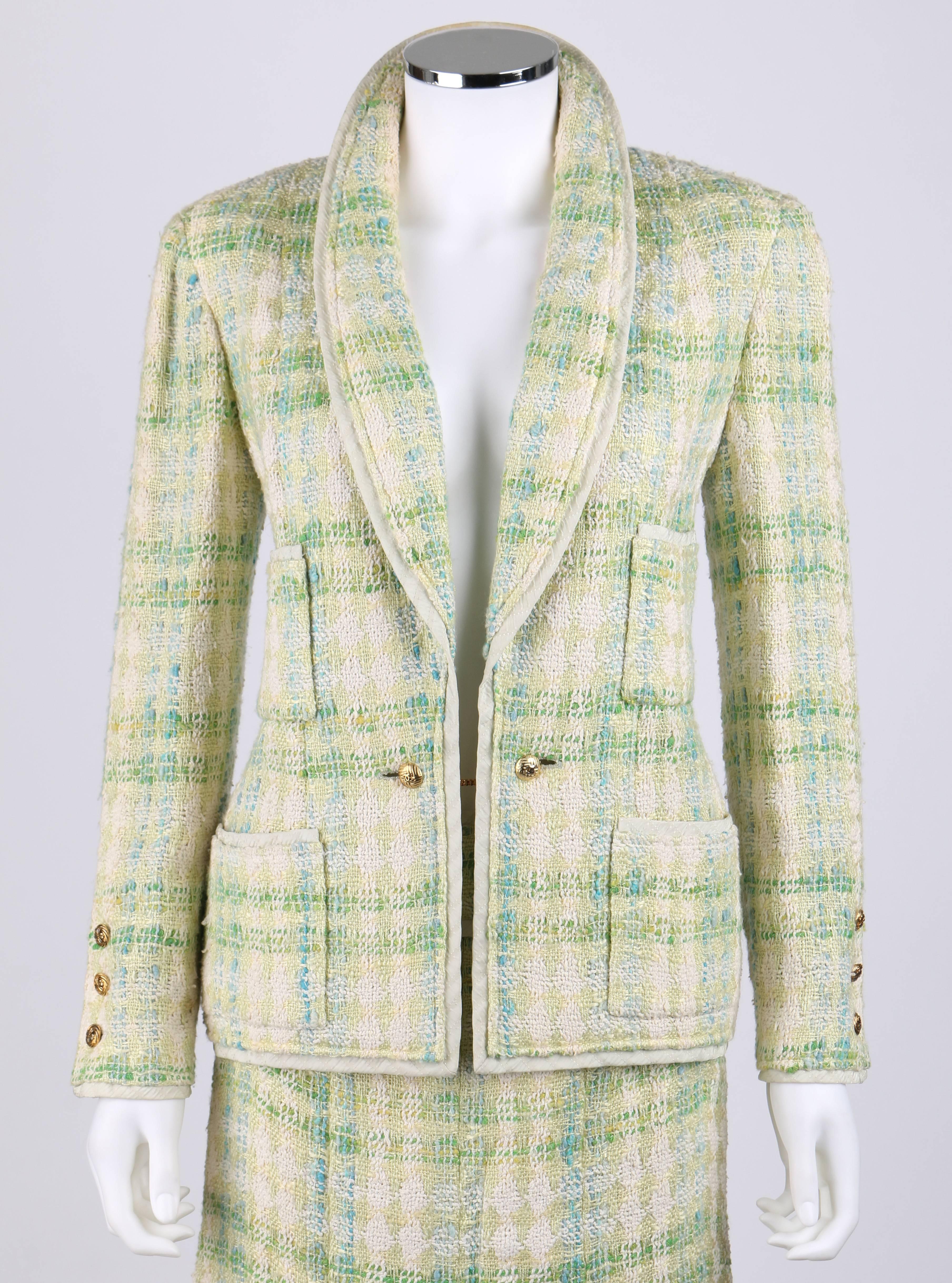 Vintage Chanel Boutique Spring/Summer 1984 two piece tweed skirt suit in shades of pale green, teal and ivory. The jacket is trimmed in textured pale green silk. Four patch pockets. Closes at front with gold-tone 