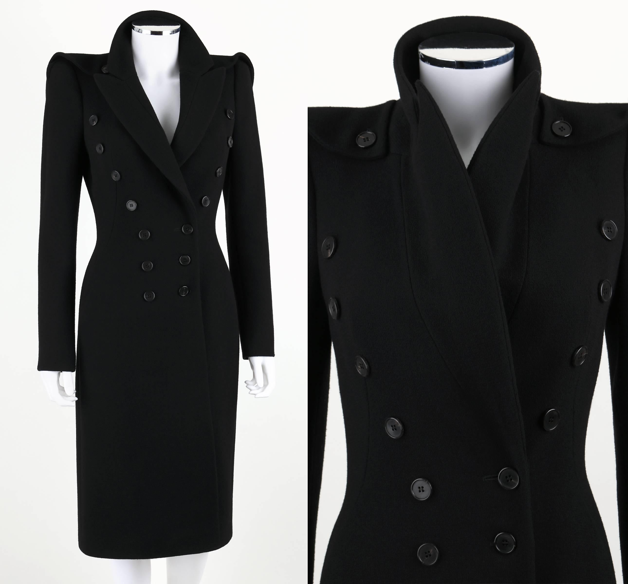 Alexander McQueen black wool crepe tailored military inspired coat from the Pre-Fall 2011 Collection. Double breasted button closure. Tailored collar/lapel. Padded shoulders with button epaulette detail. Button detail at cuffs. Two pockets. Button